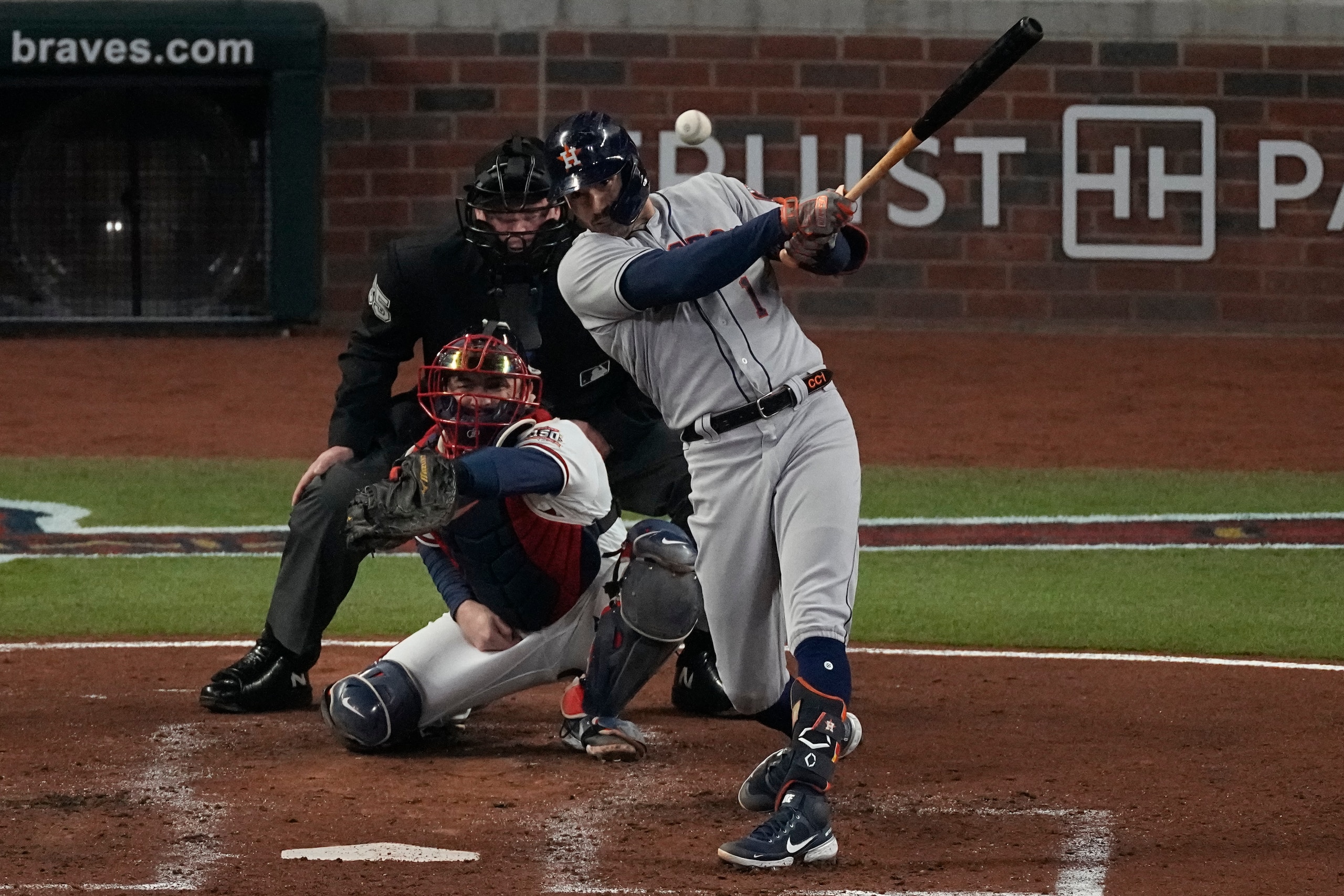 Houston Astros' Carlos Correa hits an RBI-double during the third inning in Game 5 of baseball's World Series between the Houston Astros and the Atlanta Braves Sunday, Oct. 31, 2021, in Atlanta. (AP Photo/John Bazemore)