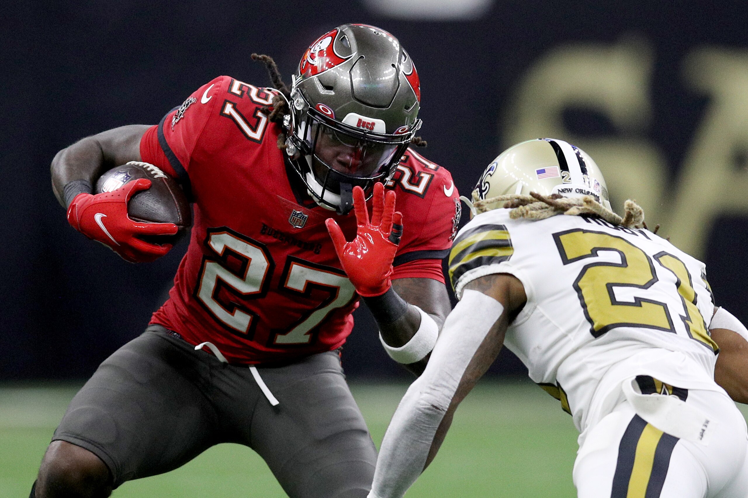 NEW ORLEANS, LOUISIANA - OCTOBER 31: Ronald Jones #27 of the Tampa Bay Buccaneers runs the ball and looks to avoid a tackle by Bradley Roby #21 of the New Orleans Saints during the second half at Caesars Superdome on October 31, 2021 in New Orleans, Louisiana. (Photo by Sean Gardner/Getty Images)