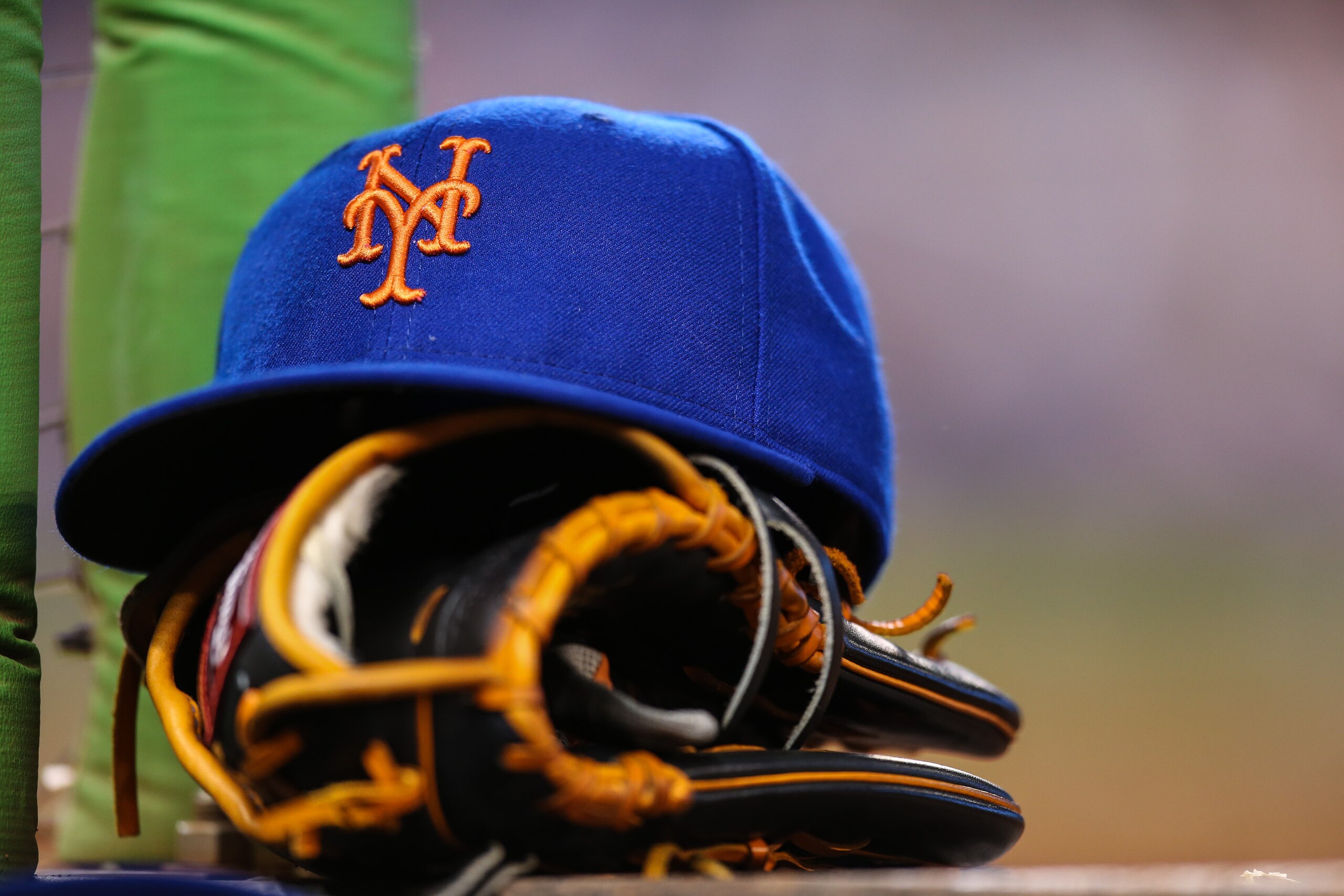 MIAMI, FL - AUGUST 04: A New York Mets hat and glove sit on the steps of the dugout during the game against the Miami Marlins at Marlins Park on August 4, 2015 in Miami, Florida.  (Photo by Rob Foldy/Getty Images)