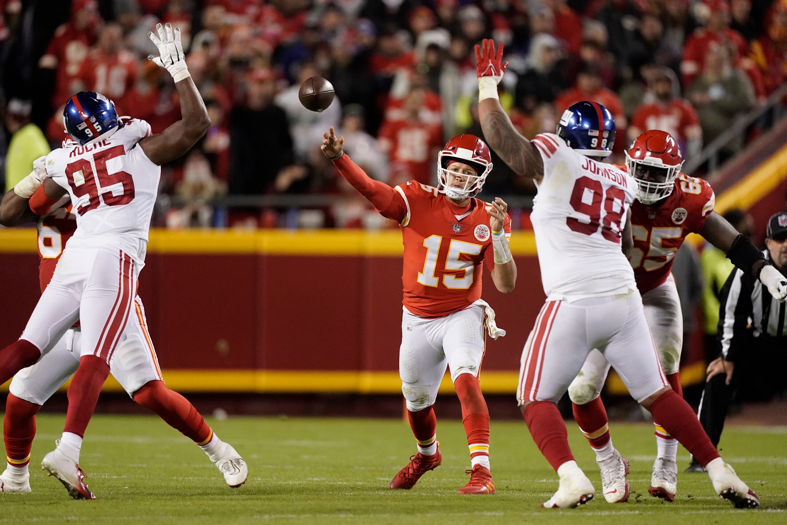 Kansas City Chiefs quarterback Patrick Mahomes throws between New York Giants linebacker Quincy Roche (95) and defensive tackle Austin Johnson (98) during the first half of an NFL football game Monday, Nov. 1, 2021, in Kansas City, Mo. (AP Photo/Charlie Riedel)