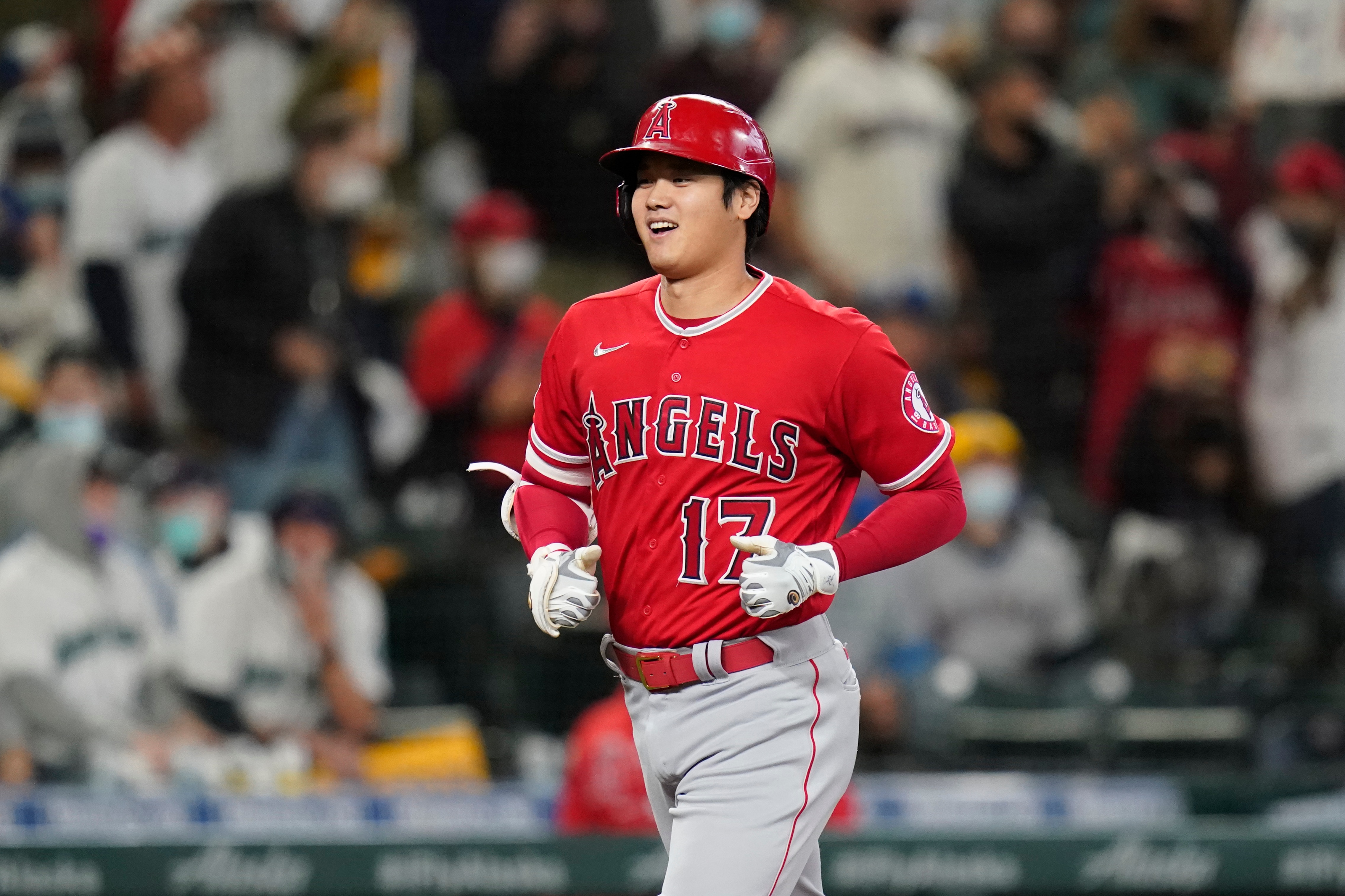 Los Angeles Angels' Shohei Ohtani heads home on his solo home run against the Seattle Mariners in the first inning of a baseball game Sunday, Oct. 3, 2021, in Seattle. (AP Photo/Elaine Thompson)