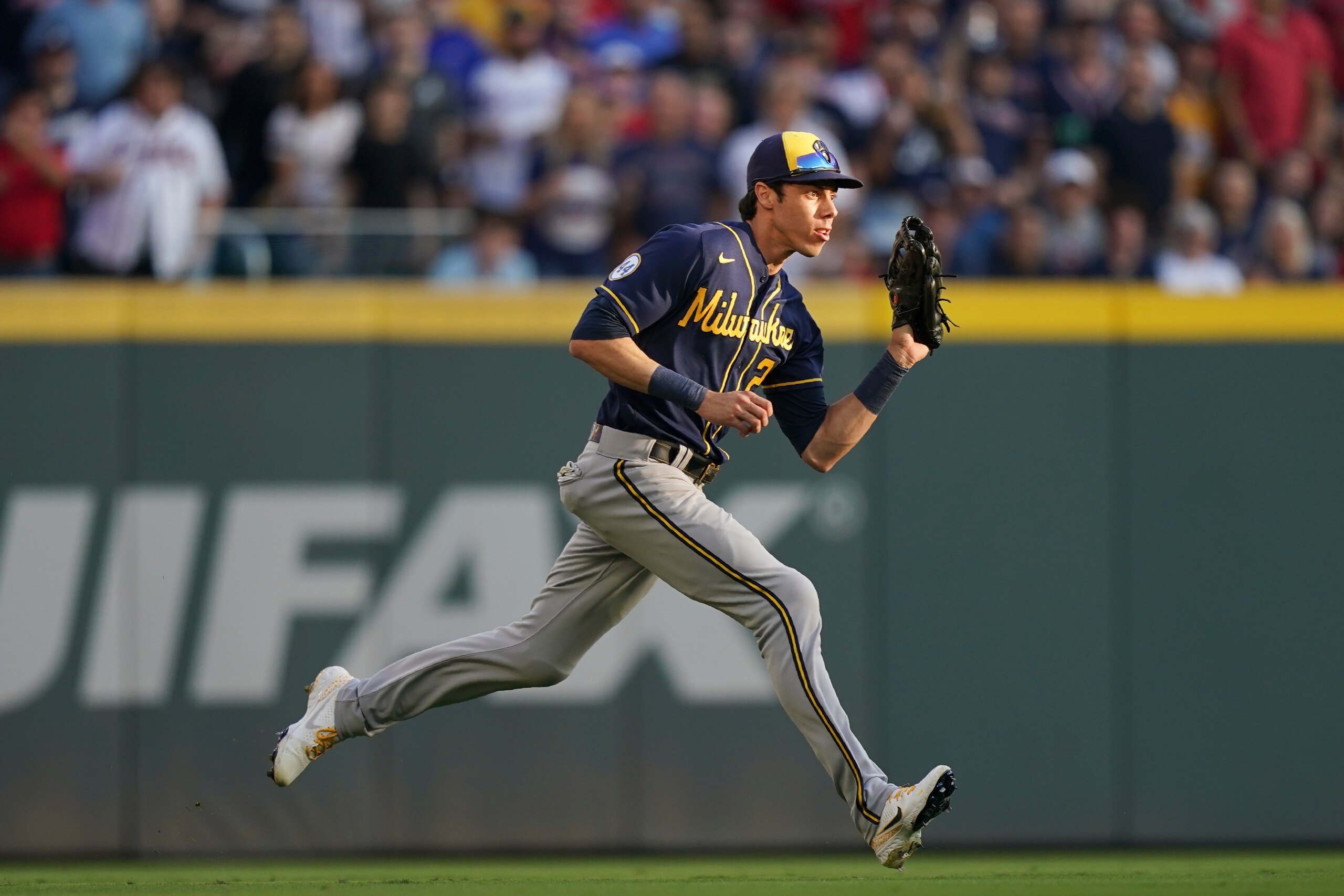 Milwaukee Brewers left fielder Christian Yelich (22) makes a catch during the second inning of Game 4 of a baseball National League Division Series against the Atlanta Braves, Tuesday, Oct. 12, 2021, in Atlanta. (AP Photo/Brynn Anderson)