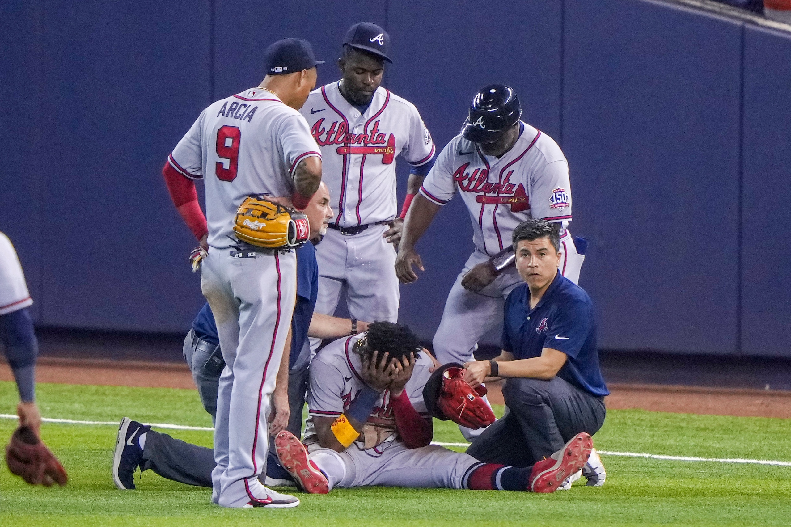 MIAMI, FL - JULY 10: Ronald Acuna Jr. #13 of the Atlanta Braves sits with his head in this hands after an injury during the fifth inning against the Miami Marlins during the fifth inning against the Miami Marlins  at loanDepot park on July 10, 2021 in Miami, Florida. (Photo by Eric Espada/Getty Images)