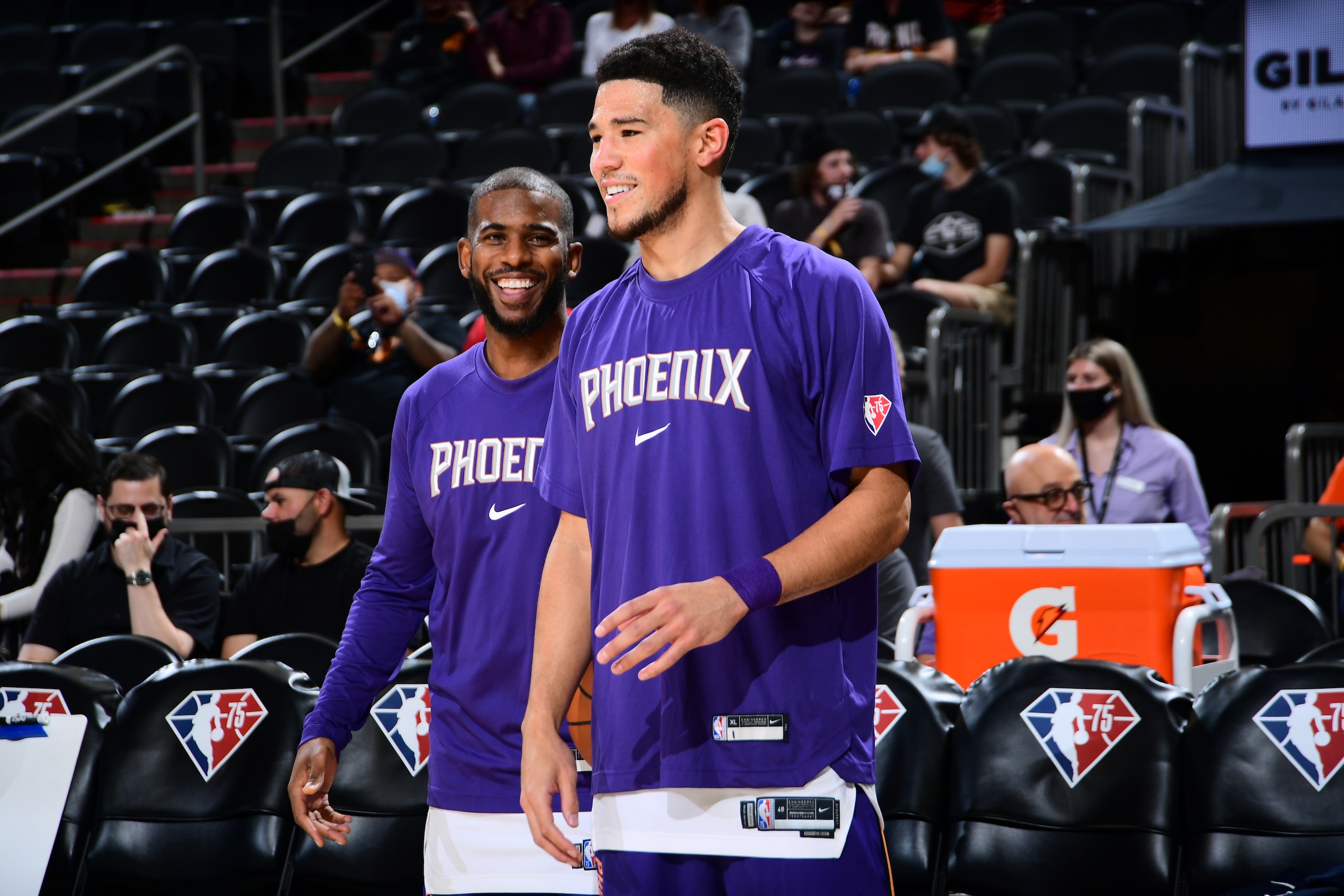 PHOENIX, AZ - NOVEMBER 2: Chris Paul #3 and Devin Booker #1 of the Phoenix Suns laugh during pregame before the game against the New Orleans Pelicans on November 2, 2021 at Footprint Center in Phoenix, Arizona. NOTE TO USER: User expressly acknowledges and agrees that, by downloading and or using this photograph, user is consenting to the terms and conditions of the Getty Images License Agreement. Mandatory Copyright Notice: Copyright 2021 NBAE (Photo by Michael Gonzales/NBAE via Getty Images)