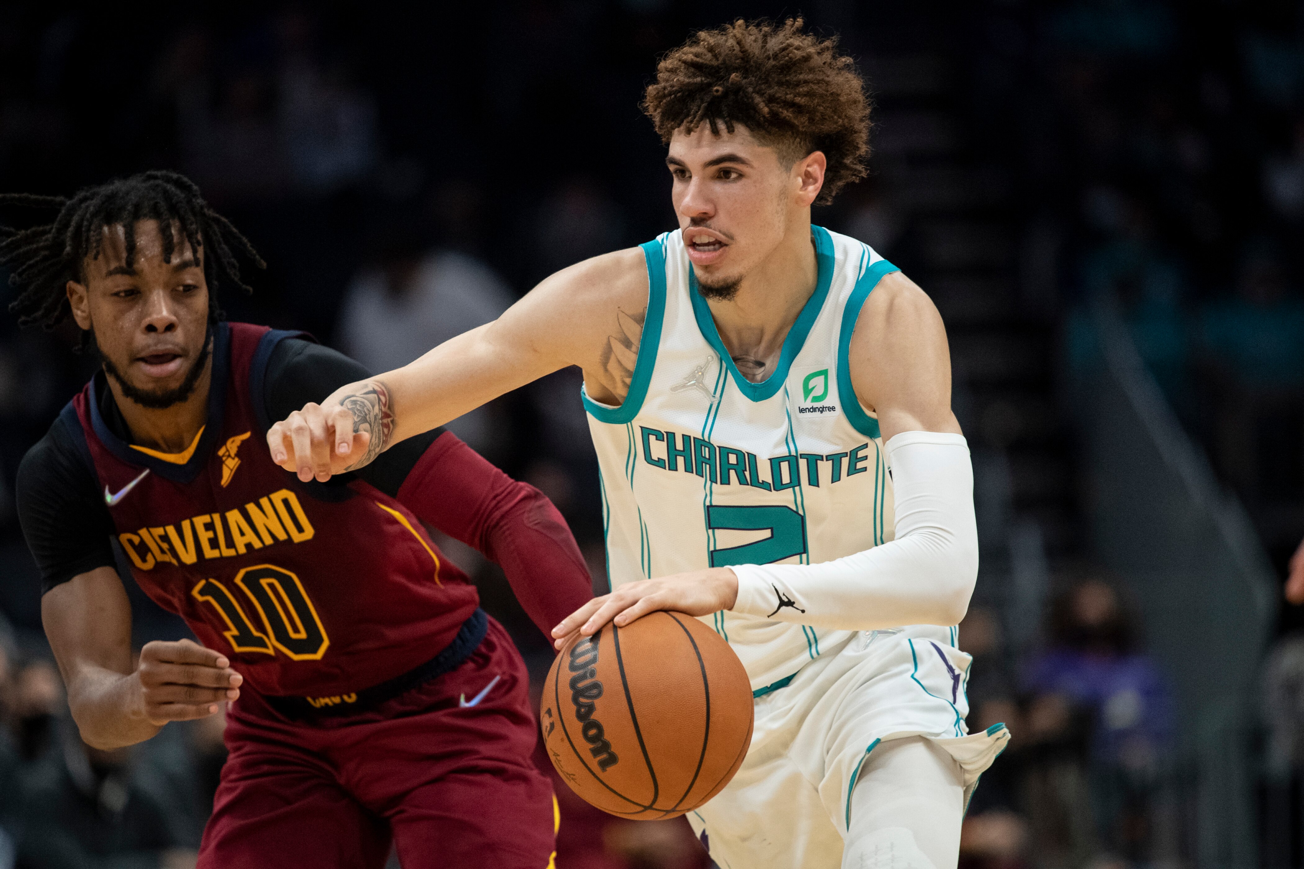 Charlotte Hornets guard LaMelo Ball (2) drives past Cleveland Cavaliers guard Darius Garland (10) during the first half of an NBA basketball game, Monday, Nov. 1, 2021, in Charlotte, N.C. (AP Photo/Matt Kelley)