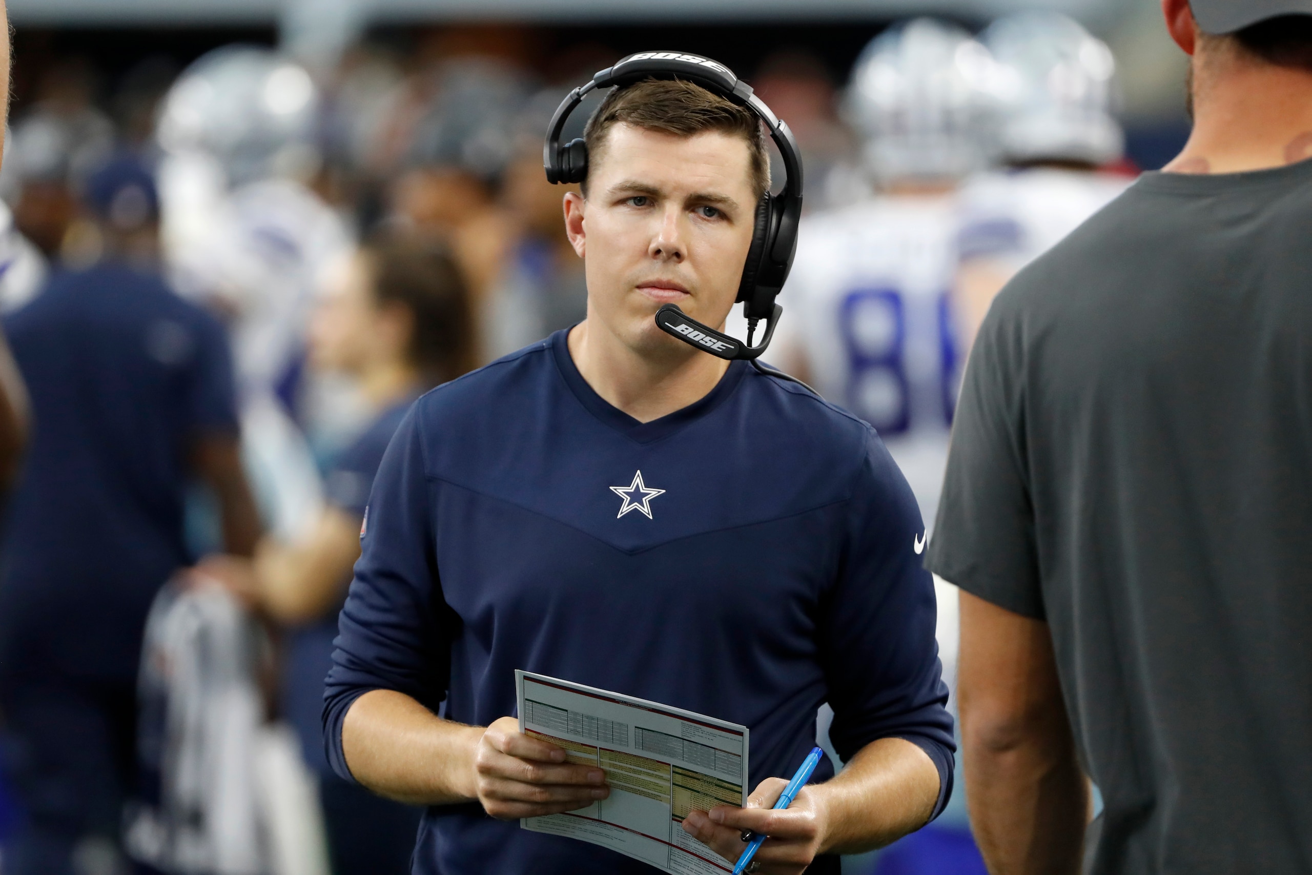 Dallas Cowboys offensive coordinator Kellen Moore walks on the sideline during the second half of an NFL football game against the Carolina Panthers in Arlington, Texas, Sunday, Oct. 3, 2021. (AP Photo/Roger Steinman)