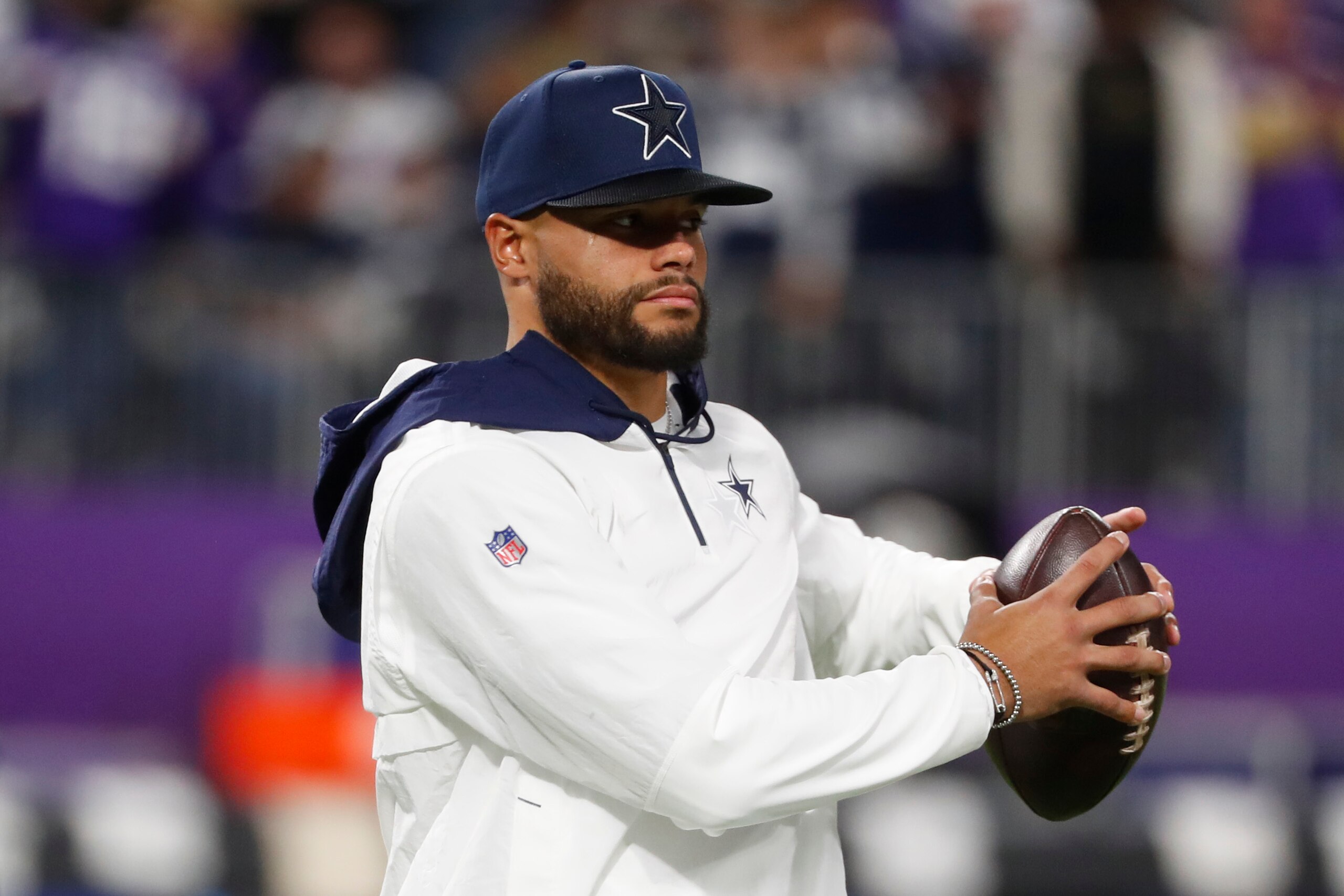 Injured Dallas Cowboys quarterback Dak Prescott stands on the field before an NFL football game against the Minnesota Vikings, Sunday, Oct. 31, 2021, in Minneapolis. (AP Photo/Bruce Kluckhohn)