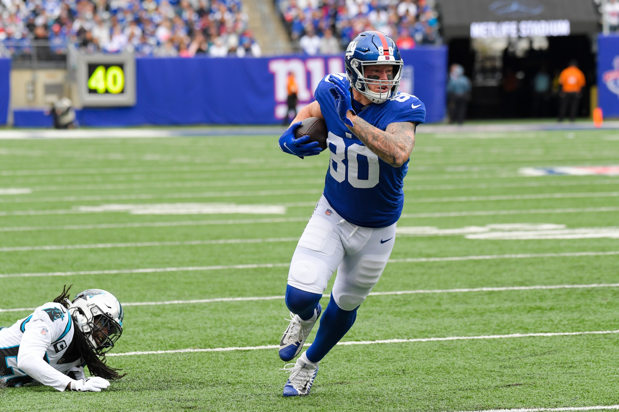 New York Giants tight end Kyle Rudolph (80) runs past Carolina Panthers' Donte Jackson (26) during the first half of an NFL football game Sunday, Oct. 24, 2021, in East Rutherford, N.J. (AP Photo/Bill Kostroun)