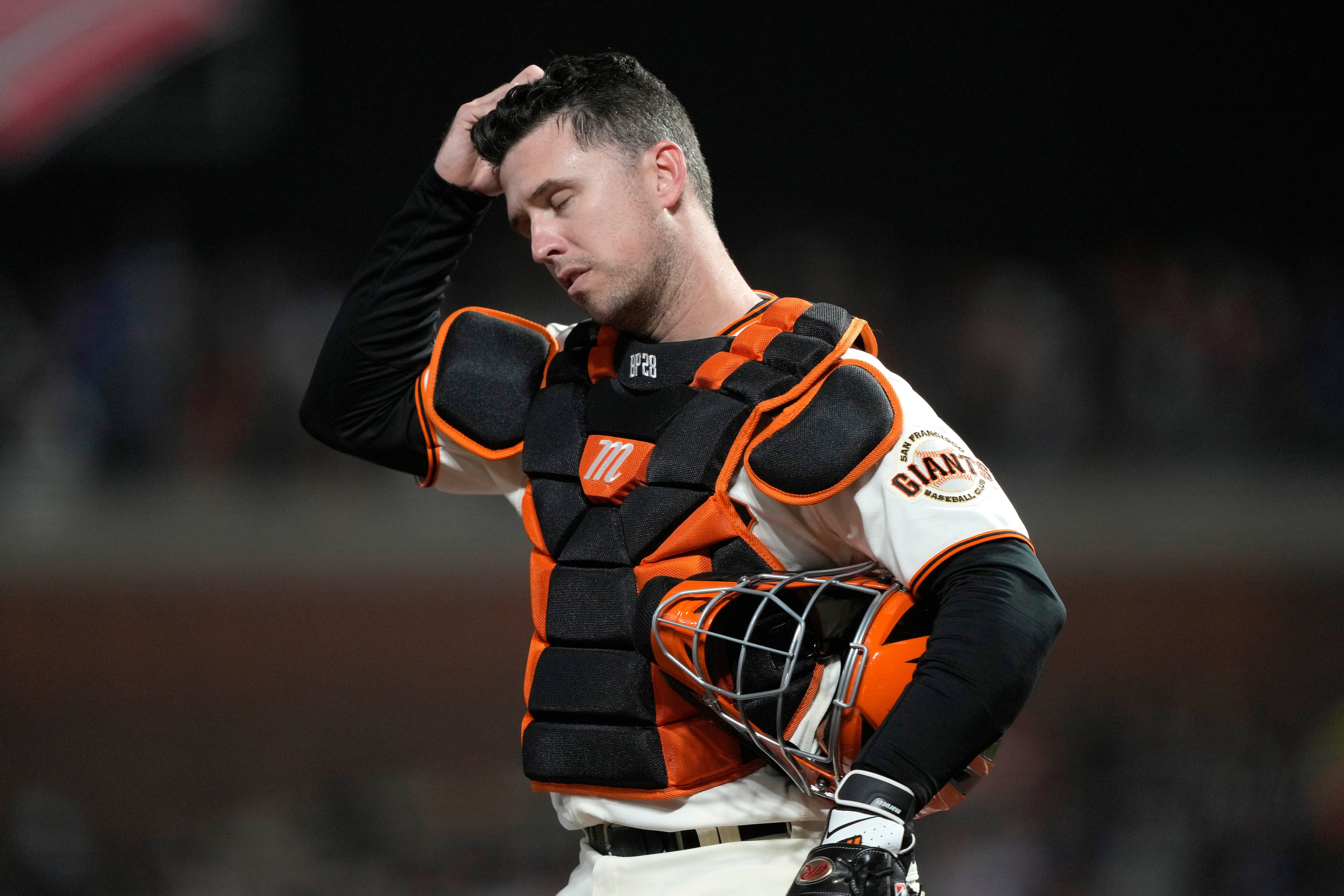 SAN FRANCISCO, CALIFORNIA - OCTOBER 14: Buster Posey #28 of the San Francisco Giants reacts after a single by Gavin Lux #9 of the Los Angeles Dodgers during the ninth inning in game 5 of the National League Division Series at Oracle Park on October 14, 2021 in San Francisco, California. (Photo by Thearon W. Henderson/Getty Images)