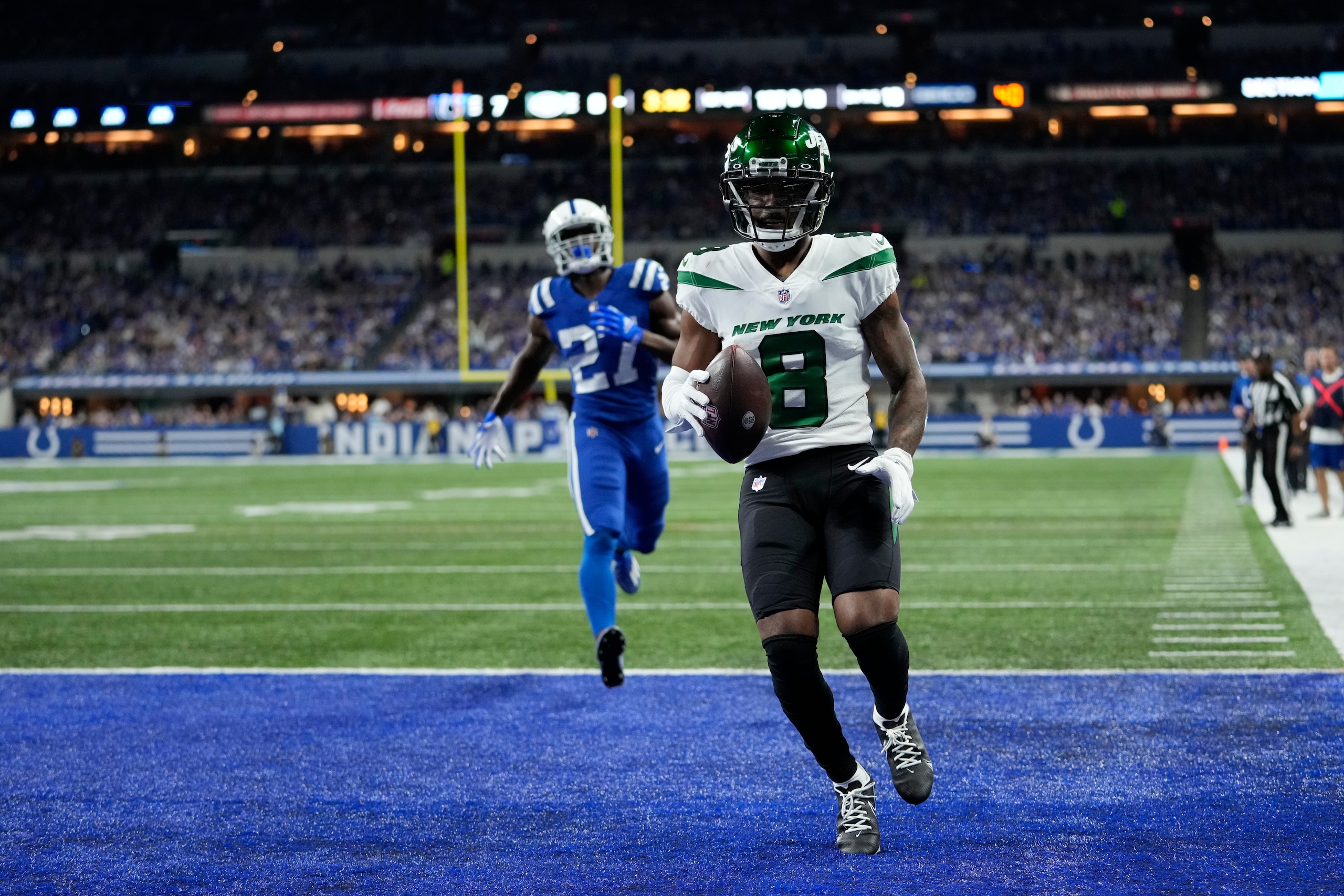 New York Jets' Elijah Moore (8) makes a touchdown reception against Indianapolis Colts' Xavier Rhodes (27) during the first half of an NFL football game, Thursday, Nov. 4, 2021, in Indianapolis. (AP Photo/AJ Mast)