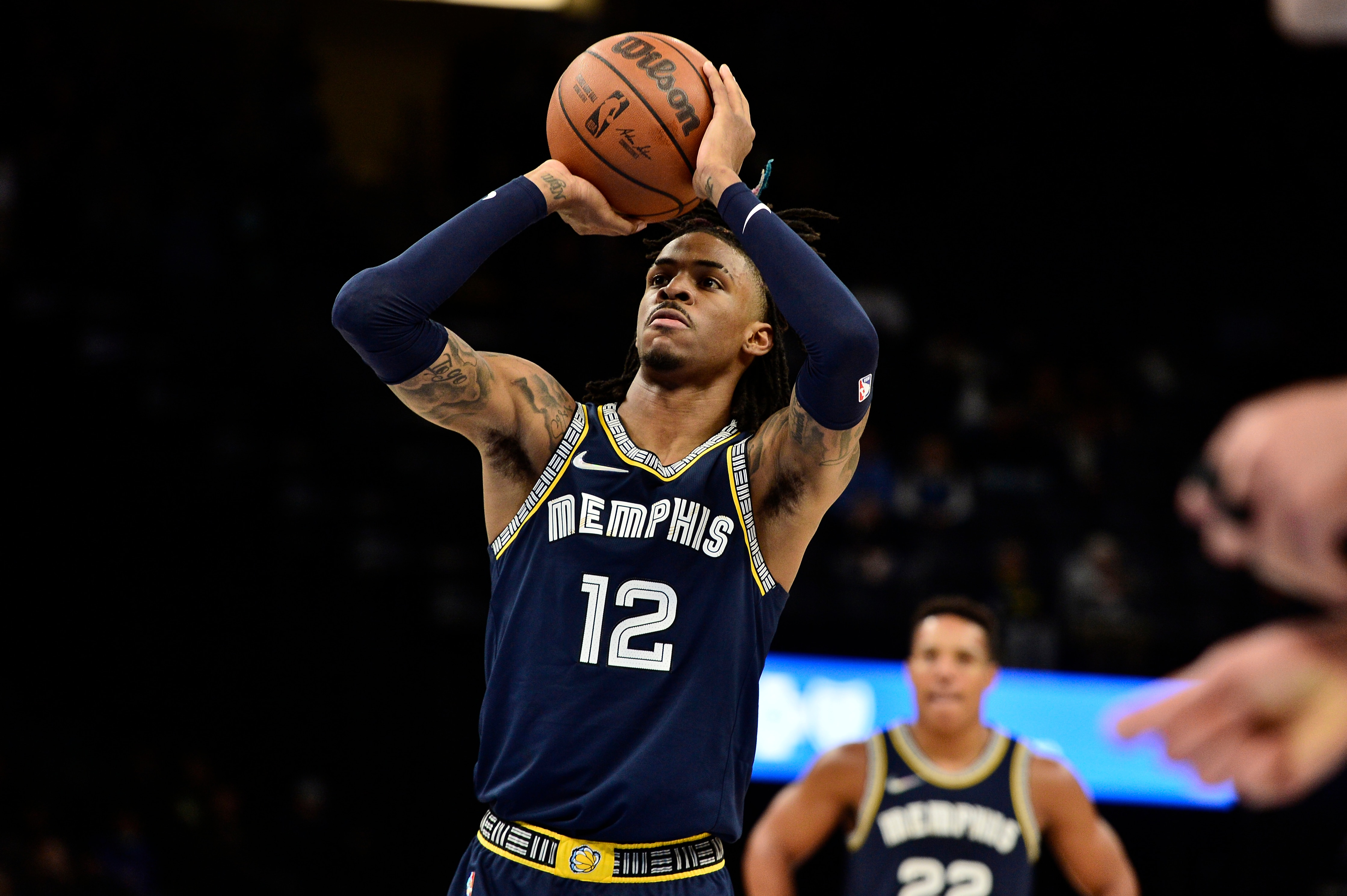 Memphis Grizzlies guard Ja Morant (12) attempts a free throw in the second half of an NBA basketball game against the Denver Nuggets Wednesday, Nov. 3, 2021, in Memphis, Tenn. (AP Photo/Brandon Dill)