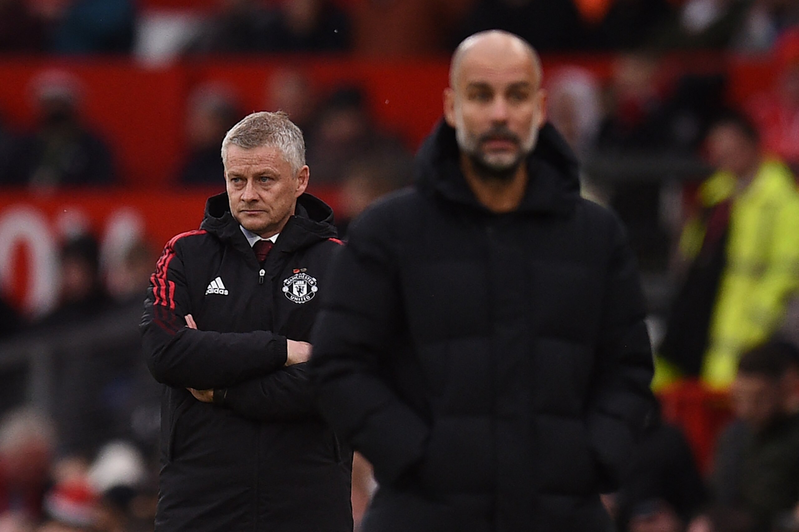Manchester United's Norwegian manager Ole Gunnar Solskjaer (L) and Manchester City's Spanish manager Pep Guardiola look on during the English Premier League football match between Manchester United and Manchester City at Old Trafford in Manchester, north west England, on November 6, 2021. - RESTRICTED TO EDITORIAL USE. No use with unauthorized audio, video, data, fixture lists, club/league logos or 'live' services. Online in-match use limited to 120 images. An additional 40 images may be used in extra time. No video emulation. Social media in-match use limited to 120 images. An additional 40 images may be used in extra time. No use in betting publications, games or single club/league/player publications. (Photo by Oli SCARFF / AFP) / RESTRICTED TO EDITORIAL USE. No use with unauthorized audio, video, data, fixture lists, club/league logos or 'live' services. Online in-match use limited to 120 images. An additional 40 images may be used in extra time. No video emulation. Social media in-match use limited to 120 images. An additional 40 images may be used in extra time. No use in betting publications, games or single club/league/player publications. / RESTRICTED TO EDITORIAL USE. No use with unauthorized audio, video, data, fixture lists, club/league logos or 'live' services. Online in-match use limited to 120 images. An additional 40 images may be used in extra time. No video emulation. Social media in-match use limited to 120 images. An additional 40 images may be used in extra time. No use in betting publications, games or single club/league/player publications. (Photo by OLI SCARFF/AFP via Getty Images)