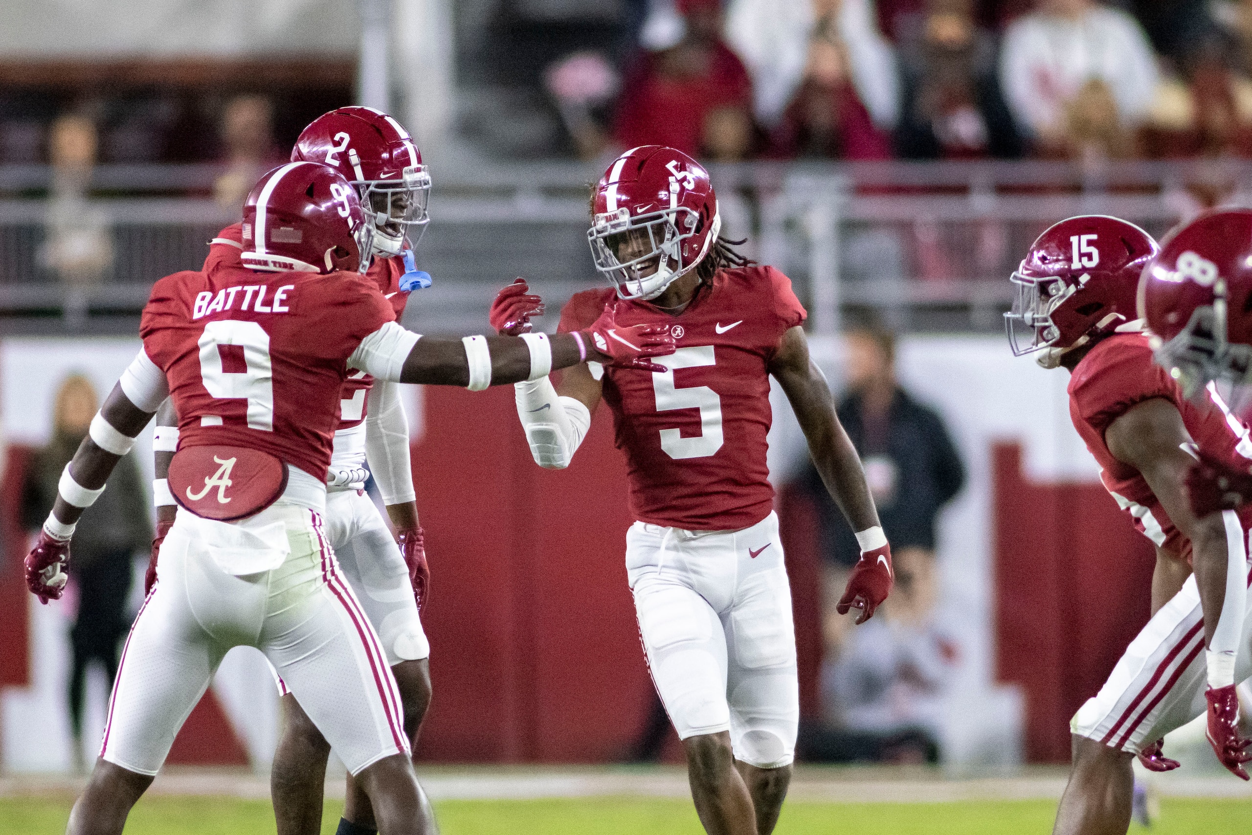 Alabama defensive backs Jordan Battle (9), DeMarcco Hellams (2) and Jalyn Armour-Davis (5) celebrate after an interception by Armour-Davis against LSU during the first half of an NCAA college football game, Saturday, Nov. 6, 2021, in Tuscaloosa, Ala. (AP Photo/Vasha Hunt)
