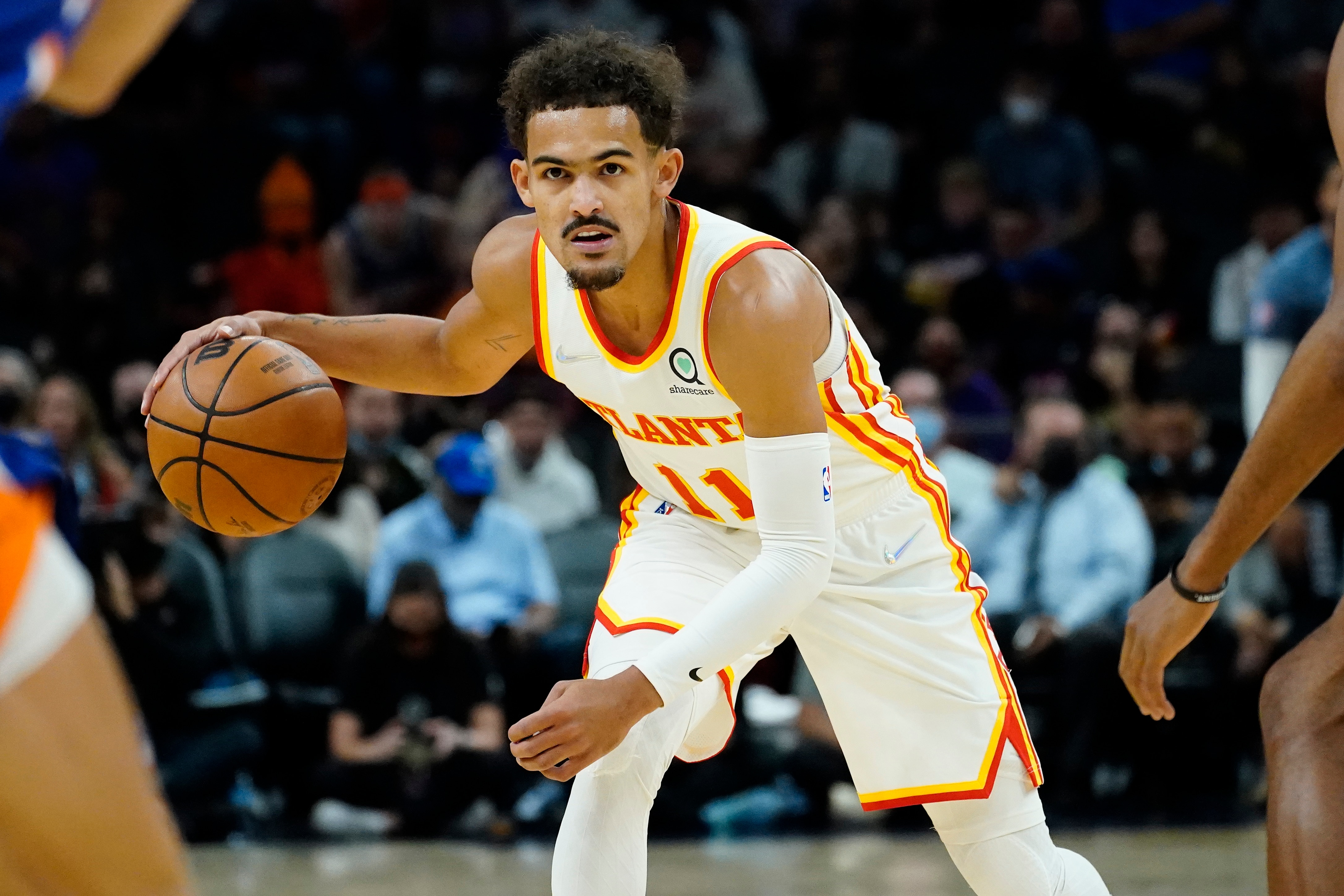 Atlanta Hawks guard Trae Young (11) looks to pass against the Phoenix Suns during the first half of an NBA basketball game, Saturday, Nov. 6, 2021, in Phoenix. (AP Photo/Matt York)