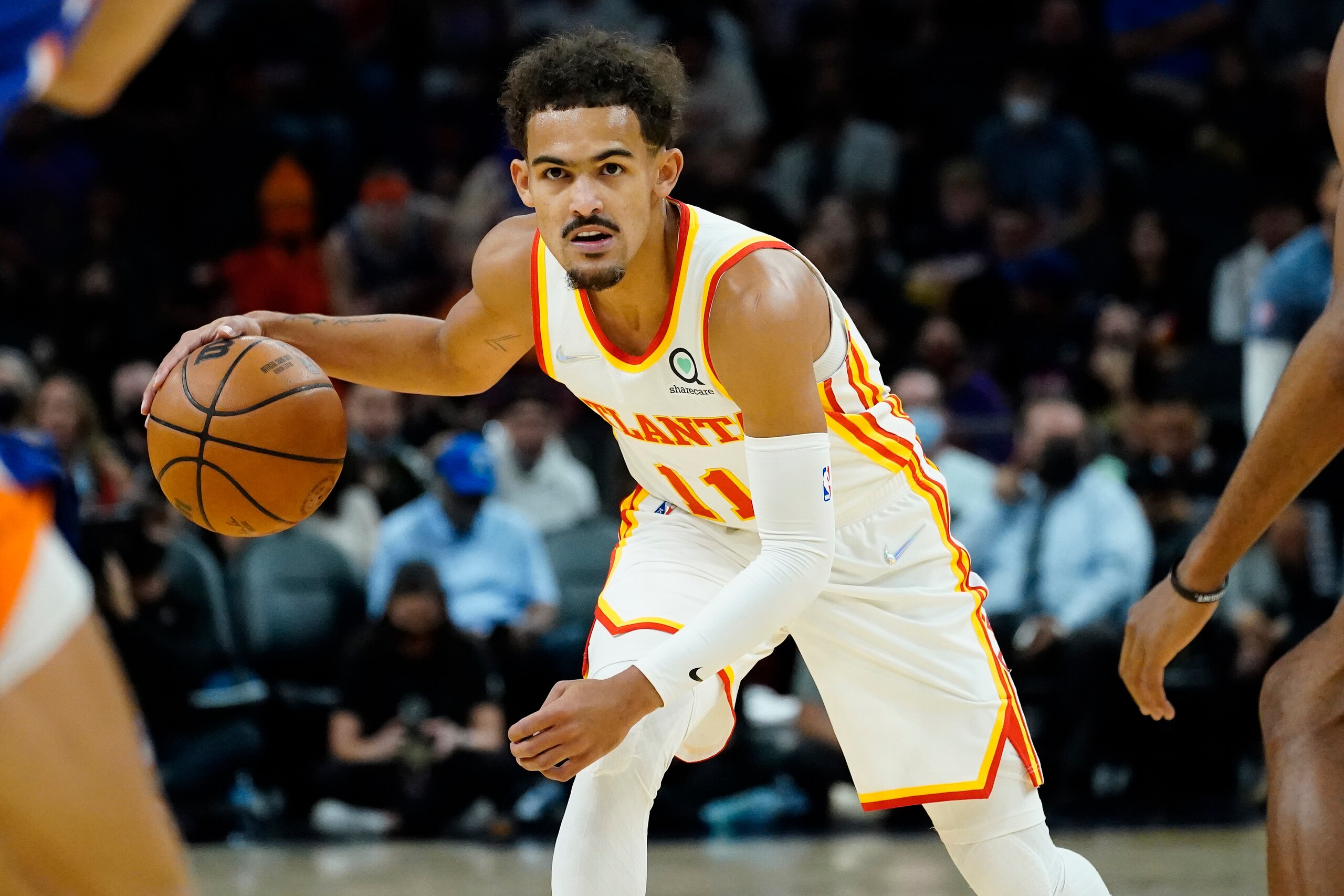 Atlanta Hawks guard Trae Young (11) looks to pass against the Phoenix Suns during the first half of an NBA basketball game, Saturday, Nov. 6, 2021, in Phoenix. (AP Photo/Matt York)