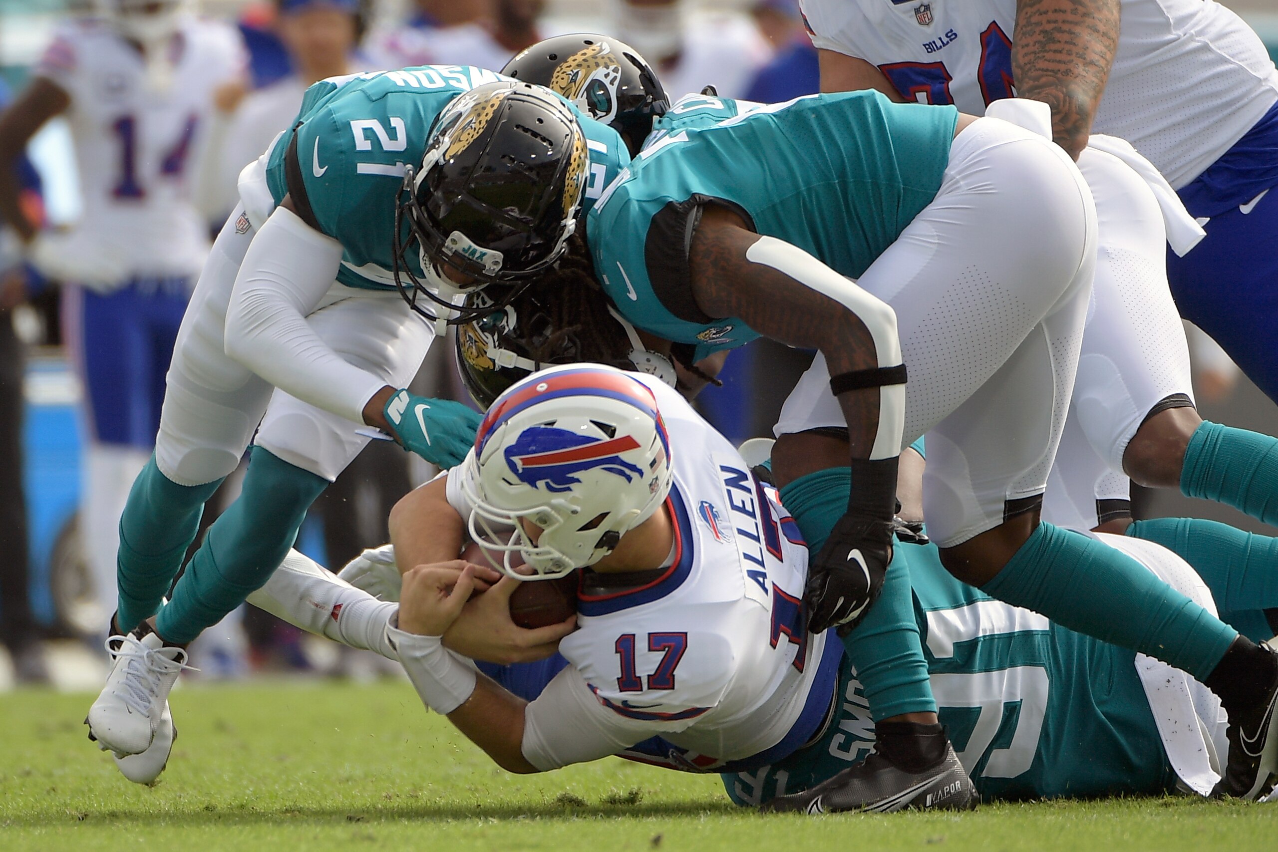 Buffalo Bills quarterback Josh Allen (17) is sacked by the Jacksonville Jaguars defense during the first half of an NFL football game, Sunday, Nov. 7, 2021, in Jacksonville, Fla. (AP Photo/Phelan M. Ebenhack)