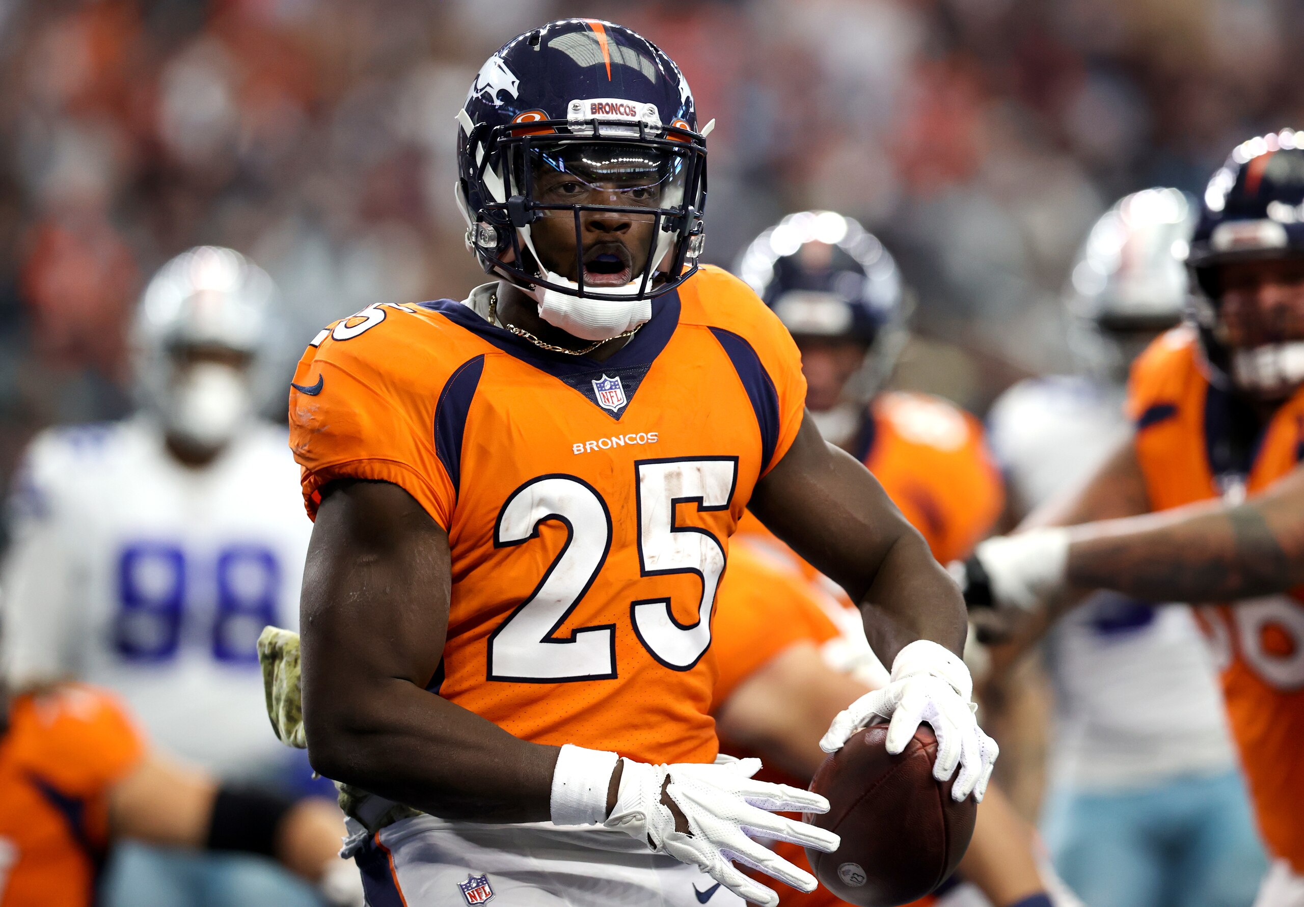 ARLINGTON, TEXAS - NOVEMBER 07: Melvin Gordon #25 of the Denver Broncos celebrates after scoring a touchdown during the first quarter against the Dallas Cowboys at AT&T Stadium on November 07, 2021 in Arlington, Texas. (Photo by Tom Pennington/Getty Images)