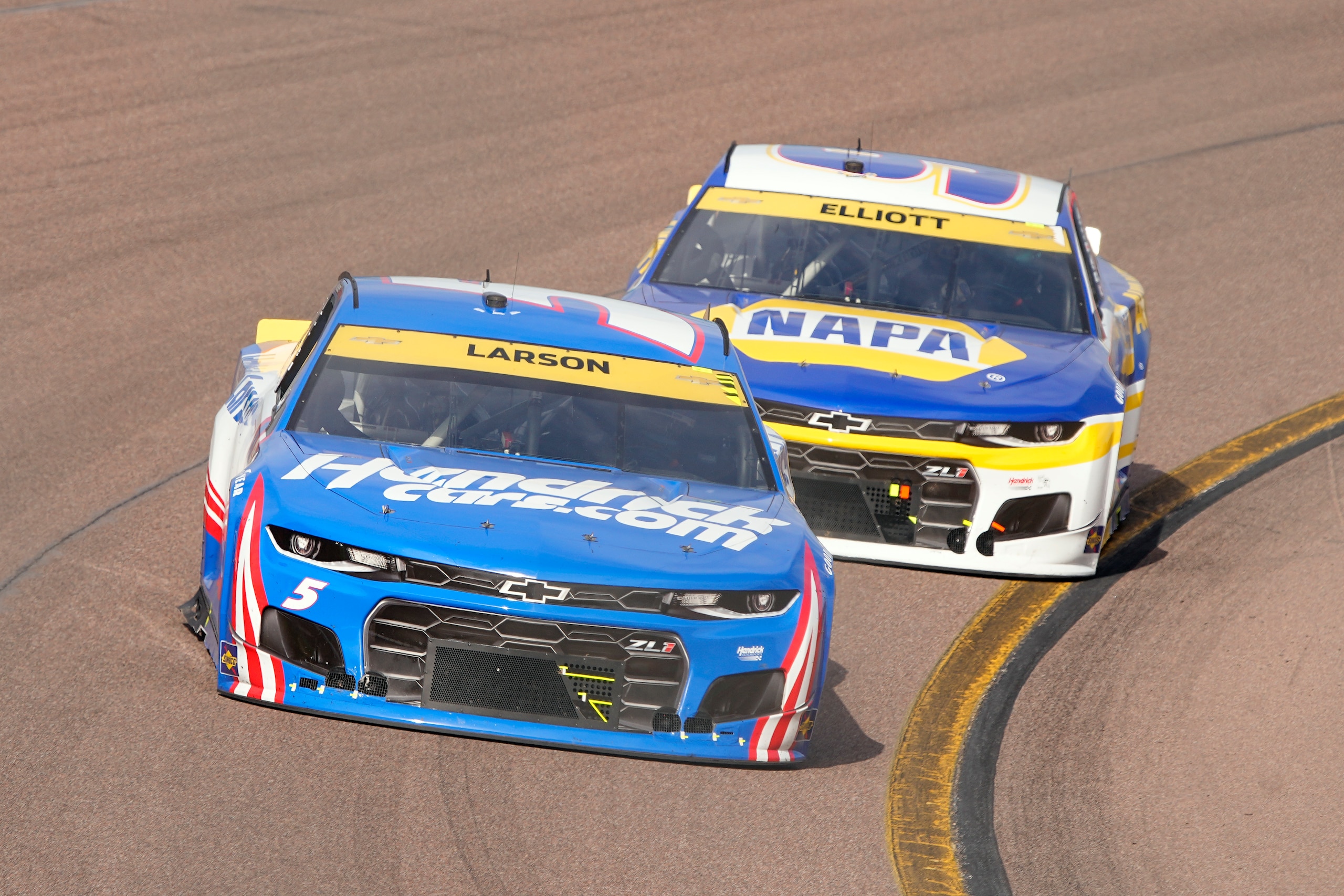 Kylr Larson leads Chase Elliott during a NASCAR Cup Series auto race on Sunday, Nov. 7, 2021, in Avondale, Ariz. (AP Photo/Rick Scuteri) Kylr Larson leads Chase Elliott during a NASCAR Cup Series auto race on Sunday, Nov. 7, 2021, in Avondale, Ariz. (AP Photo/Rick Scuteri)