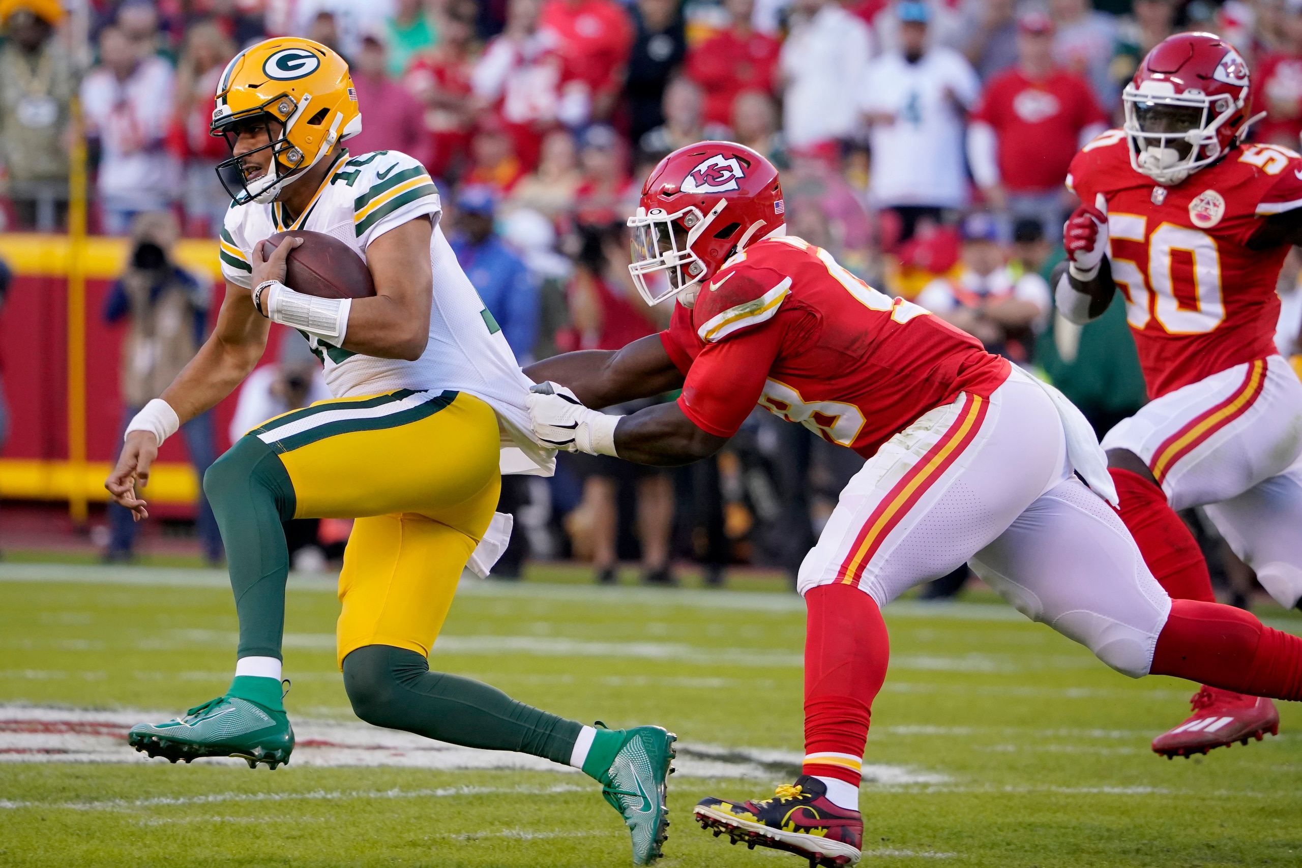 Green Bay Packers quarterback Jordan Love, left, is pulled down by Kansas City Chiefs defensive tackle Tershawn Wharton, right, during the first half of an NFL football game Sunday, Nov. 7, 2021, in Kansas City, Mo. (AP Photo/Ed Zurga)