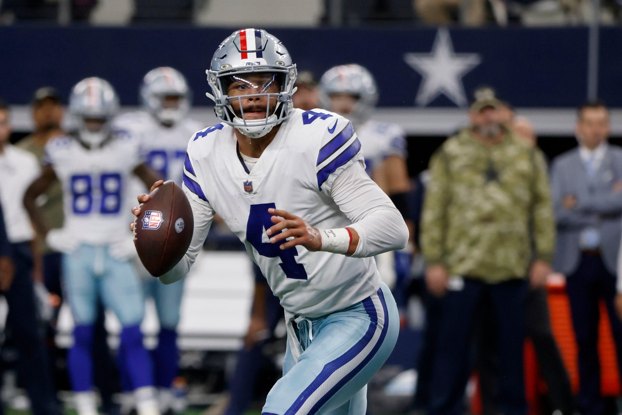 Dallas Cowboys quarterback Dak Prescott rolls out of the pocket before throwing a pass in the second half of an NFL football game against the Denver Broncos in Arlington, Texas, Sunday, Nov. 7, 2021. (AP Photo/Michael Ainsworth)