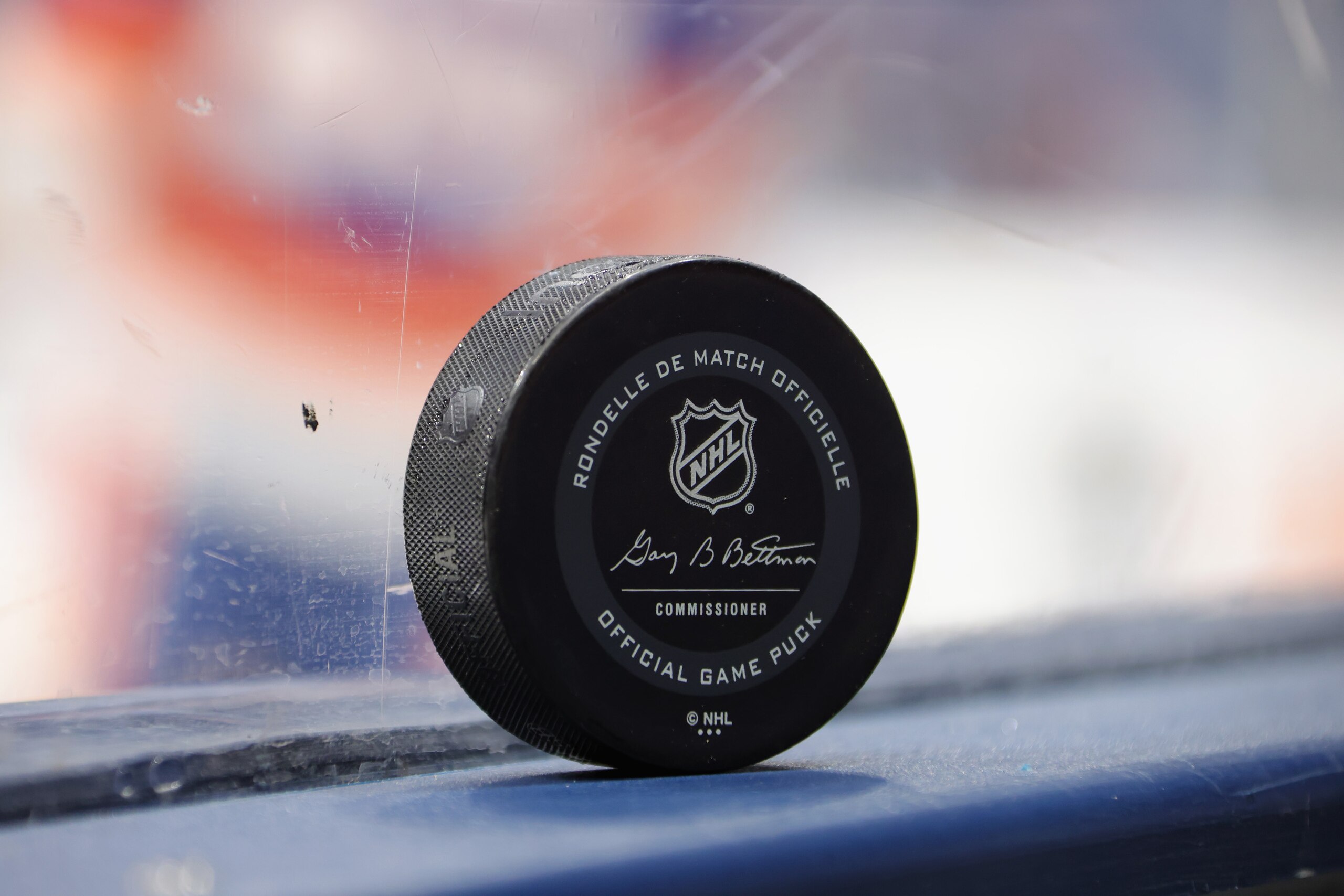 UNIONDALE, NEW YORK - JANUARY 18: An NHL puck bearing the name of commissioner Gary Bettman is photographed on the boards prior to the game between the New York Islanders and the Boston Bruins at Nassau Coliseum on January 18, 2021 in Uniondale, New York. (Photo by Bruce Bennett/Getty Images)