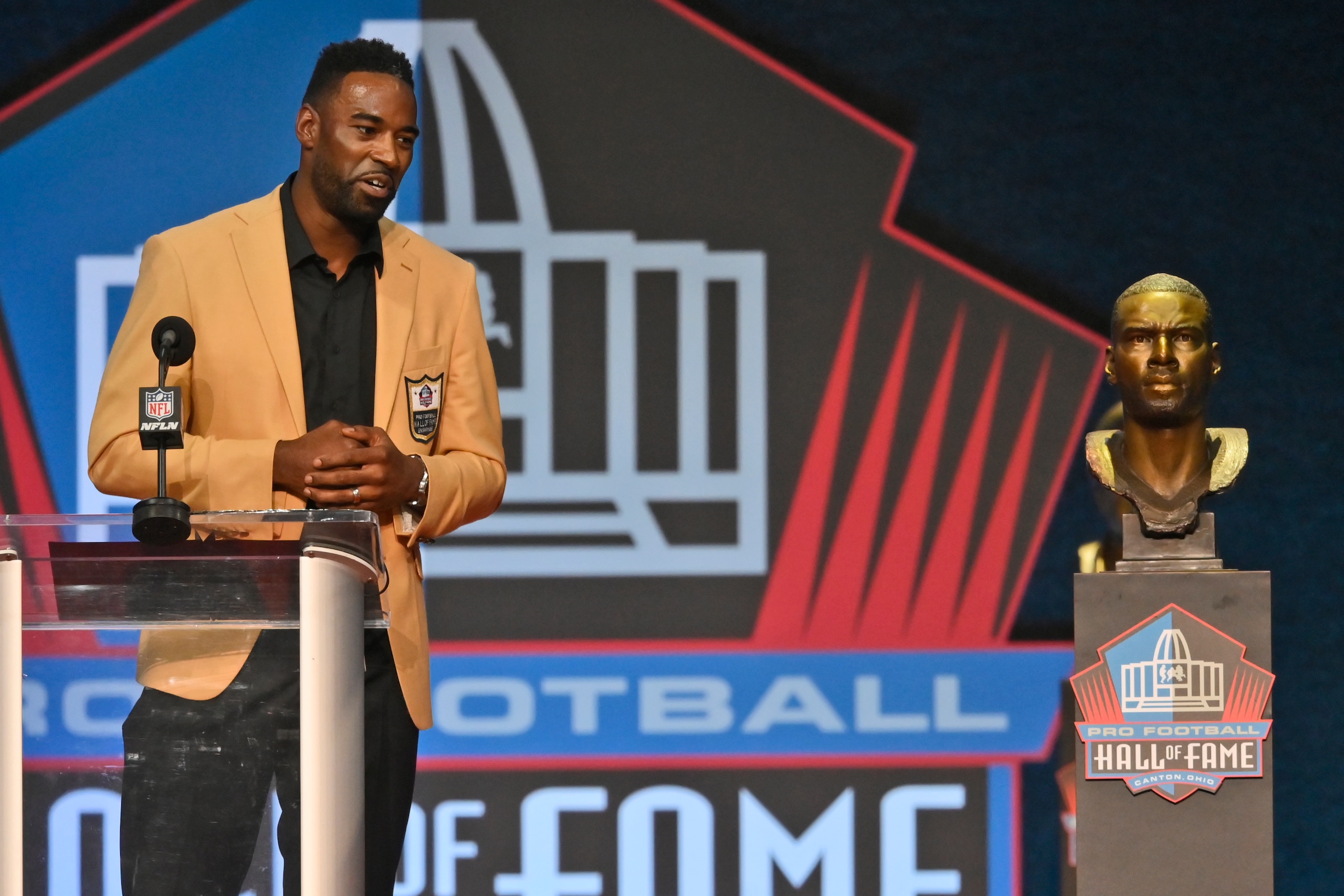 Calvin Johnson, a member of the Pro Football Hall of Fame Class of 2021, speaks during the induction ceremony at the Pro Football Hall of Fame, Sunday, Aug. 8, 2021, in Canton, Ohio. (AP Photo/David Richard)