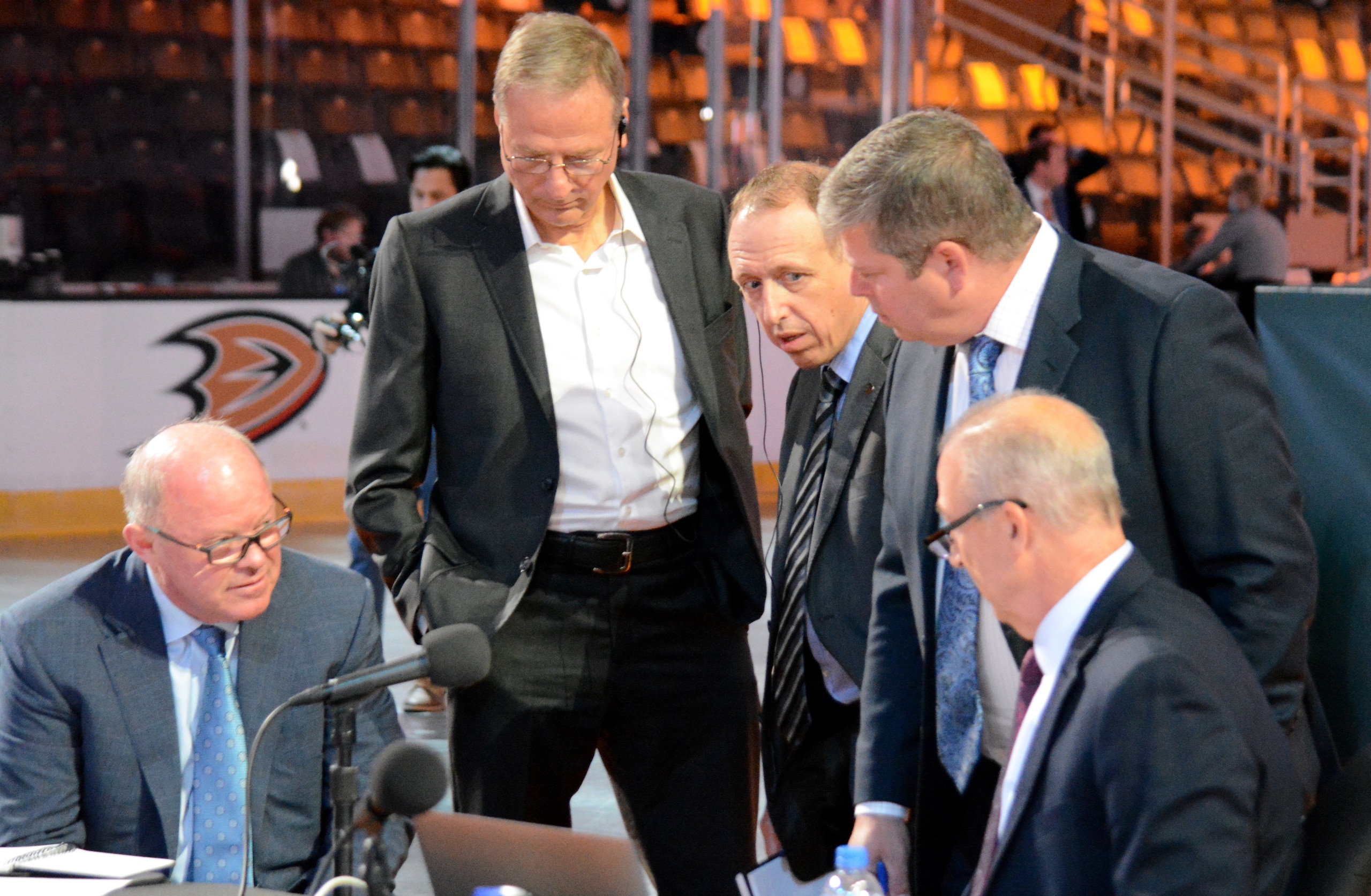 ANAHEIM, CALIFORNIA - JULY 23: Director of Amateur Scouting Martin Madden huddles with general manager Bob Murray and owner Henry Samueli of the Anaheim Ducks during the first round of the 2021 NHL Entry Draft at Honda Center on July 23, 2021 in Anaheim, California. (Photo by Adam Brady/NHLI via Getty Images)