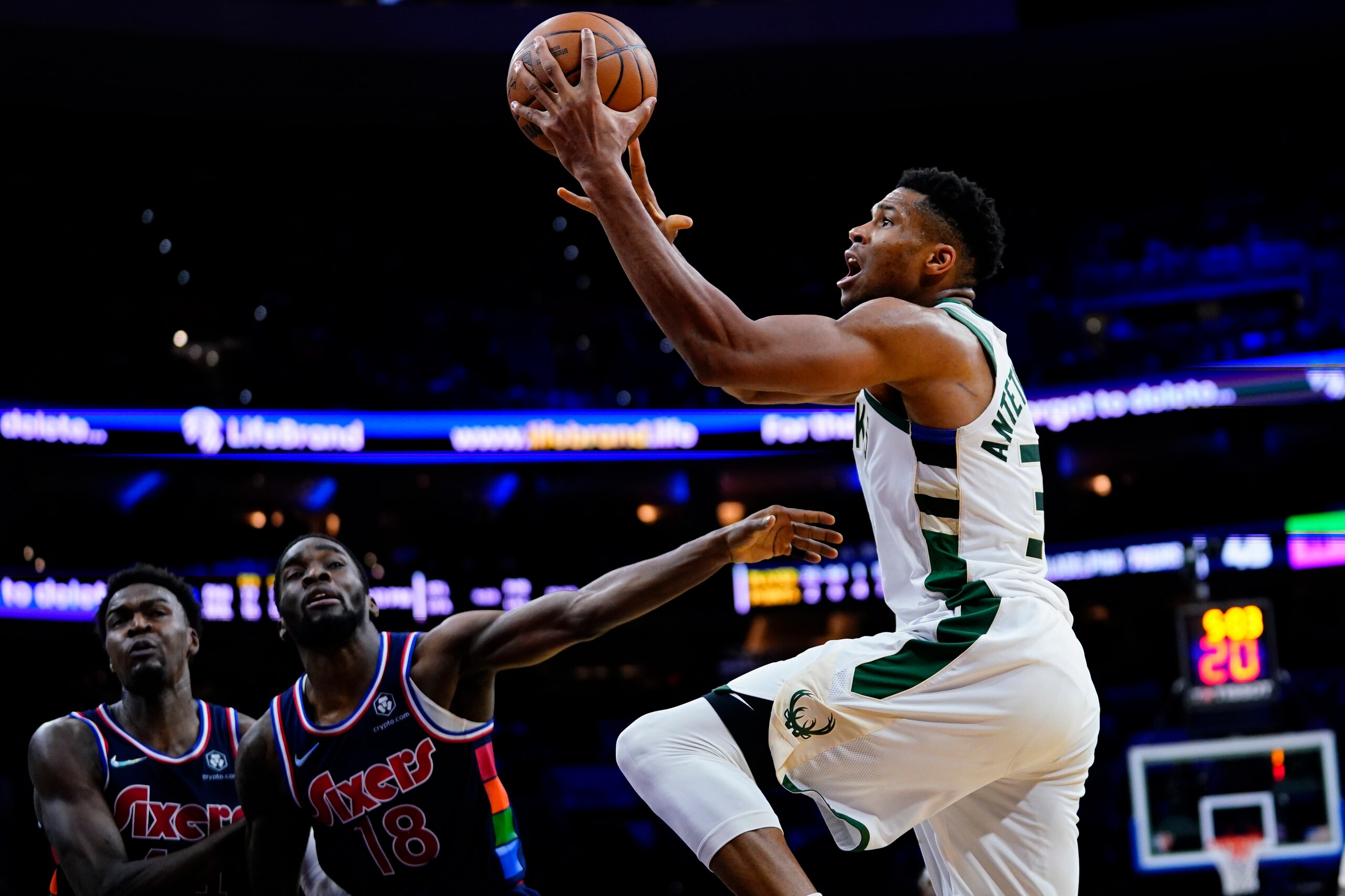 Milwaukee Bucks' Giannis Antetokounmpo, right, goes up for a shot during the first half of an NBA basketball game against the Philadelphia 76ers, Tuesday, Nov. 9, 2021, in Philadelphia. (AP Photo/Matt Slocum)