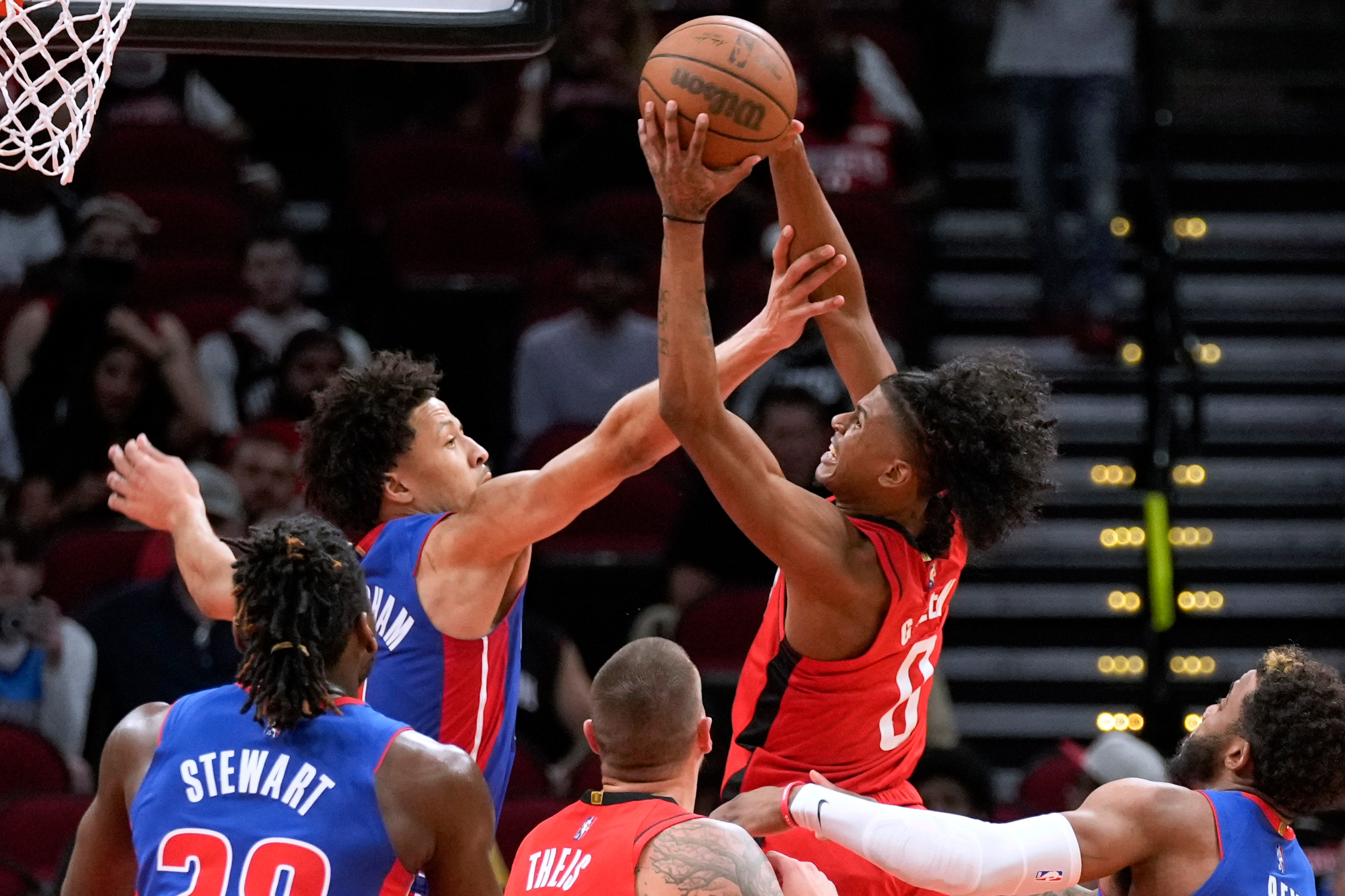 Houston Rockets guard Jalen Green, right, drives to the basket as Detroit Pistons guard Cade Cunningham, left rear, defends during the first half of an NBA basketball game Wednesday, Nov. 10, 2021, in Houston. (AP Photo/Eric Christian Smith)