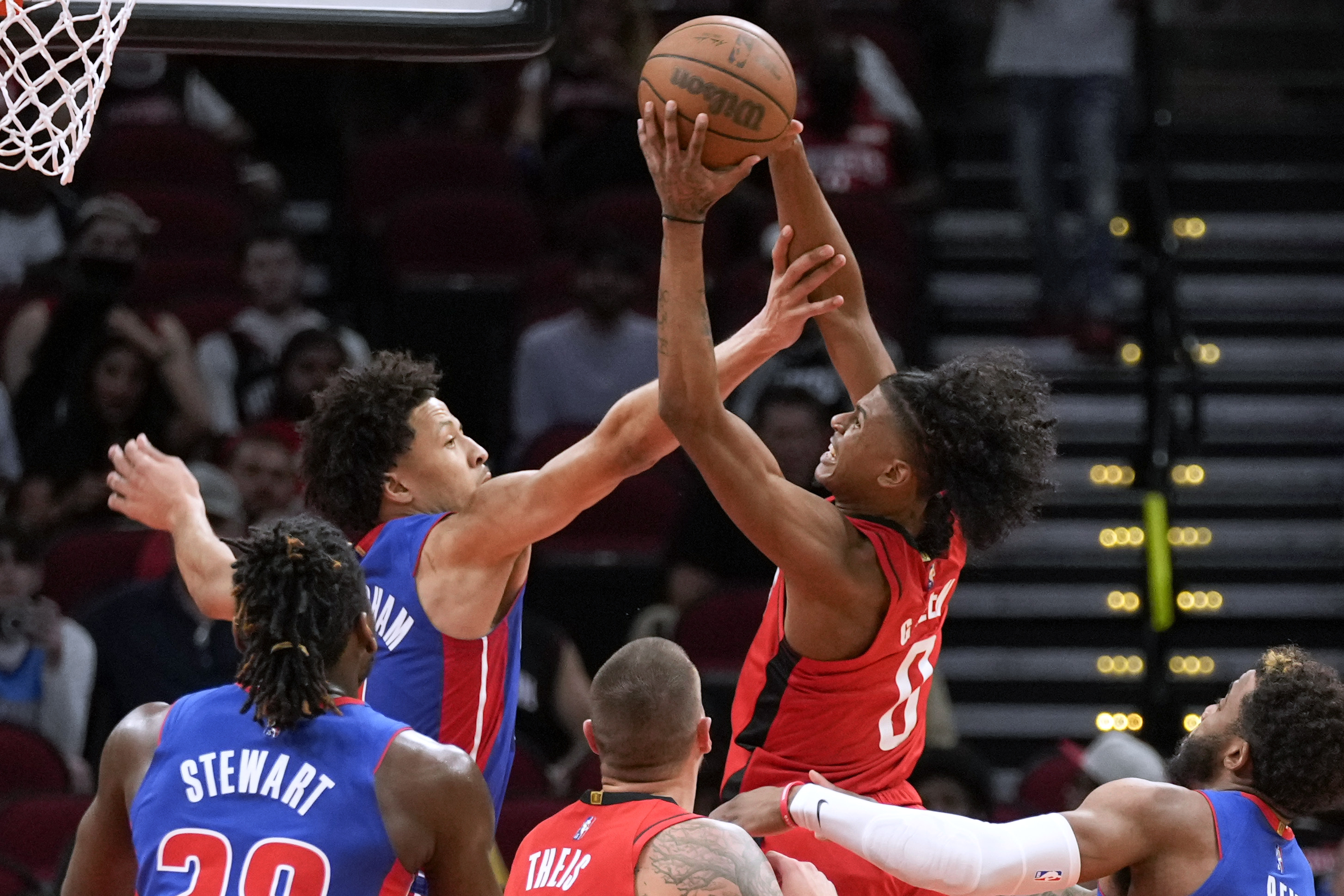 Houston Rockets guard Jalen Green, right, drives to the basket as Detroit Pistons guard Cade Cunningham, left rear, defends during the first half of an NBA basketball game Wednesday, Nov. 10, 2021, in Houston. (AP Photo/Eric Christian Smith)