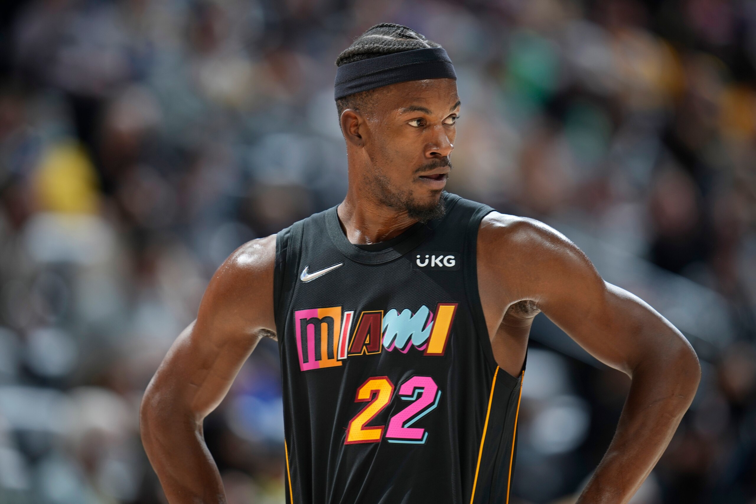 Miami Heat forward Jimmy Butler looks on in the first half of an NBA basketball game against the Denver Nuggets, Monday, Nov. 8, 2021, in Denver. (AP Photo/David Zalubowski)