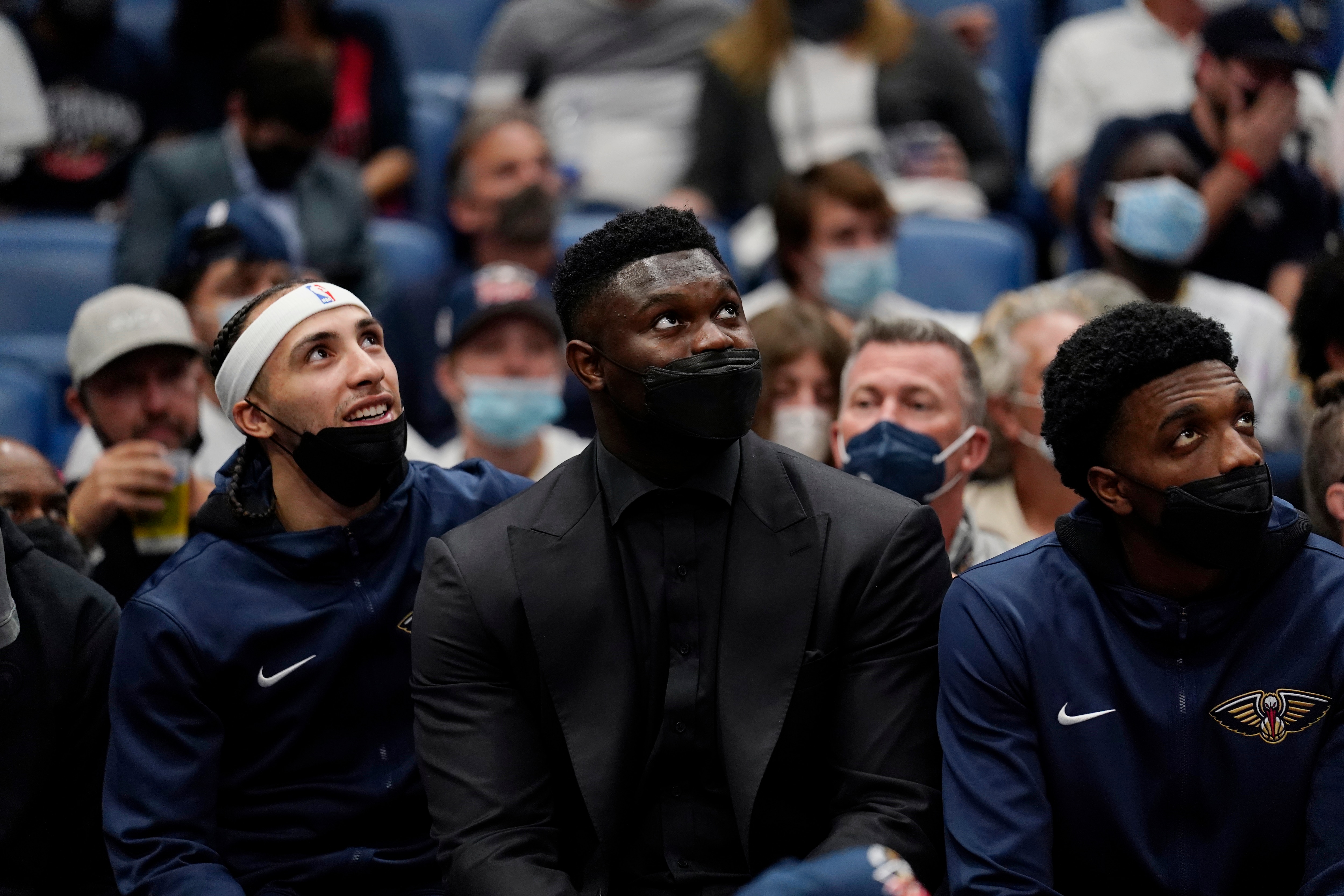 New Orleans Pelicans forward Zion Williamson, center, sits on the bench in street clothes in the second half of an NBA basketball game against the Philadelphia 76ers in New Orleans, Wednesday, Oct. 20, 2021. The 76ers won 117-97. (AP Photo/Gerald Herbert)