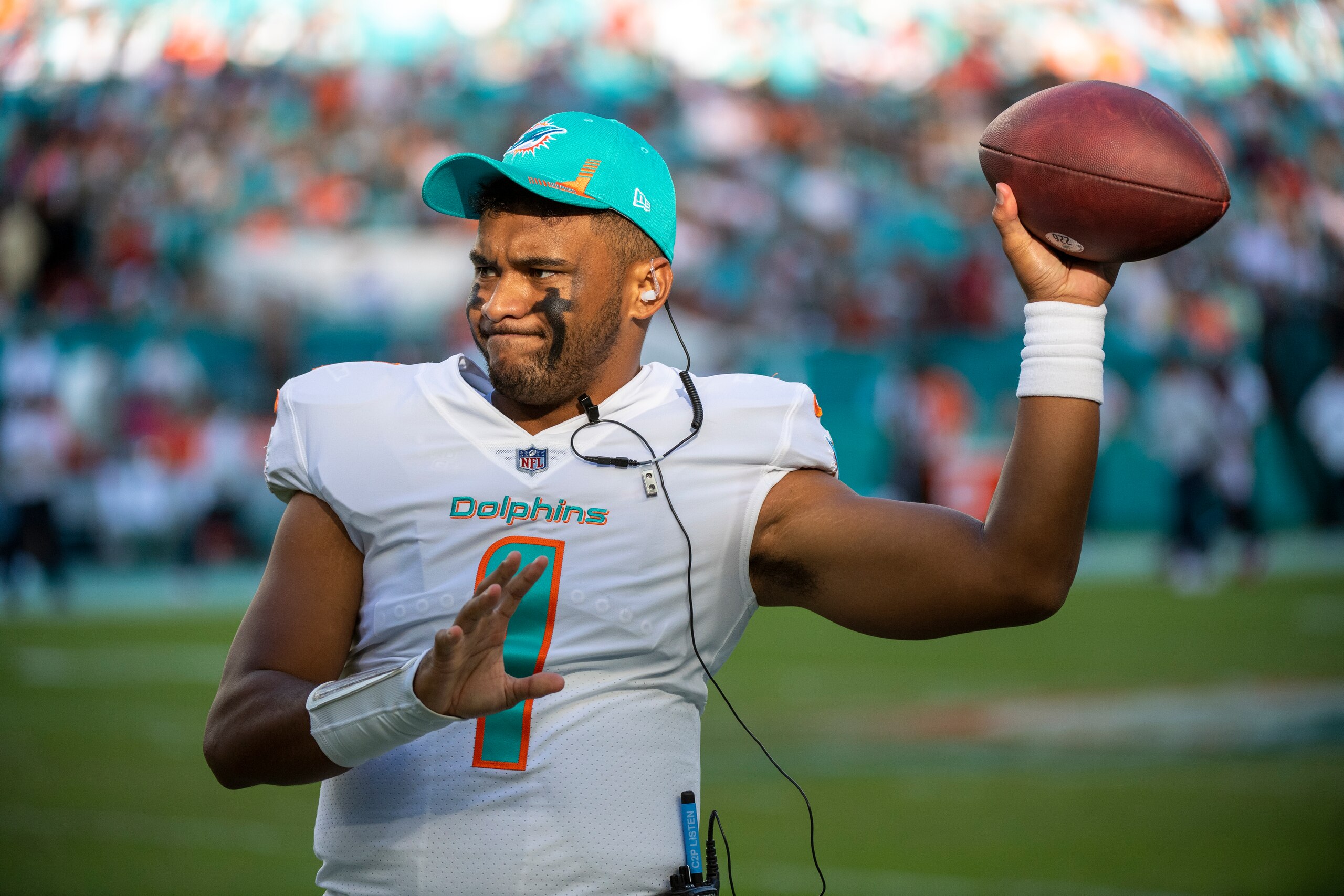Miami Dolphins quarterback Tua Tagovailoa (1) throws the ball to Miami Dolphins quarterback Jacoby Brissett (not shown) as Brissett warms up before going on the field during an NFL football game against the Houston Texans, Sunday Nov. 7, 2021, in Miami Gardens, Fla. (AP Photo/Doug Murray)
