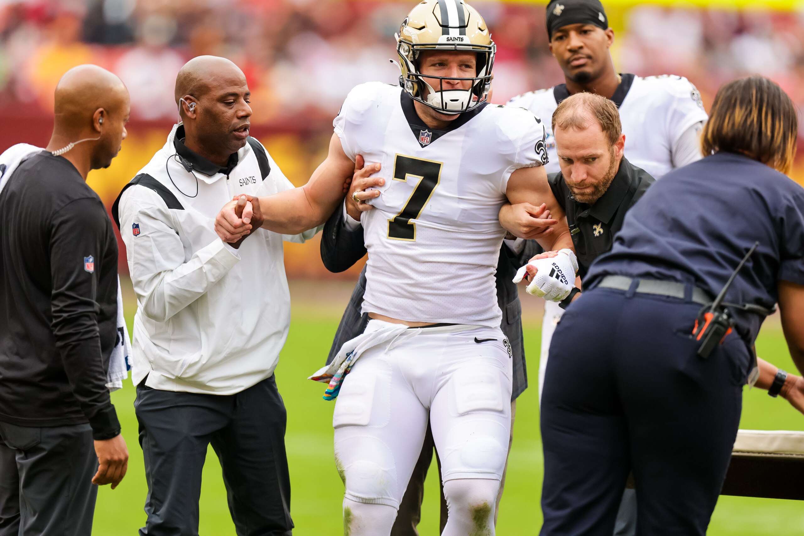 LANDOVER, MD - OCTOBER 10:  New Orleans Saints wide receiver Taysom Hill (7) is carted off the field after a hit to the head during the first half at a NFL game between the Washington Football Team and the New Orleans Saints on October 10, 2021 at the FedExField in Landover, MD. (Photo by Stephen Lew/Icon Sportswire via Getty Images)