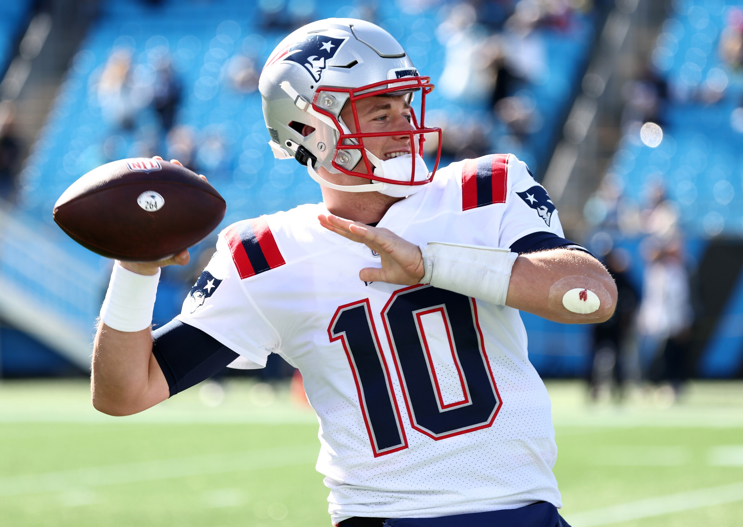 CHARLOTTE, NORTH CAROLINA - NOVEMBER 07: Mac Jones #10 of the New England Patriots throws the ball during pregame warm-ups before the game against the Carolina Panthers at Bank of America Stadium on November 07, 2021 in Charlotte, North Carolina. (Photo by Grant Halverson/Getty Images)