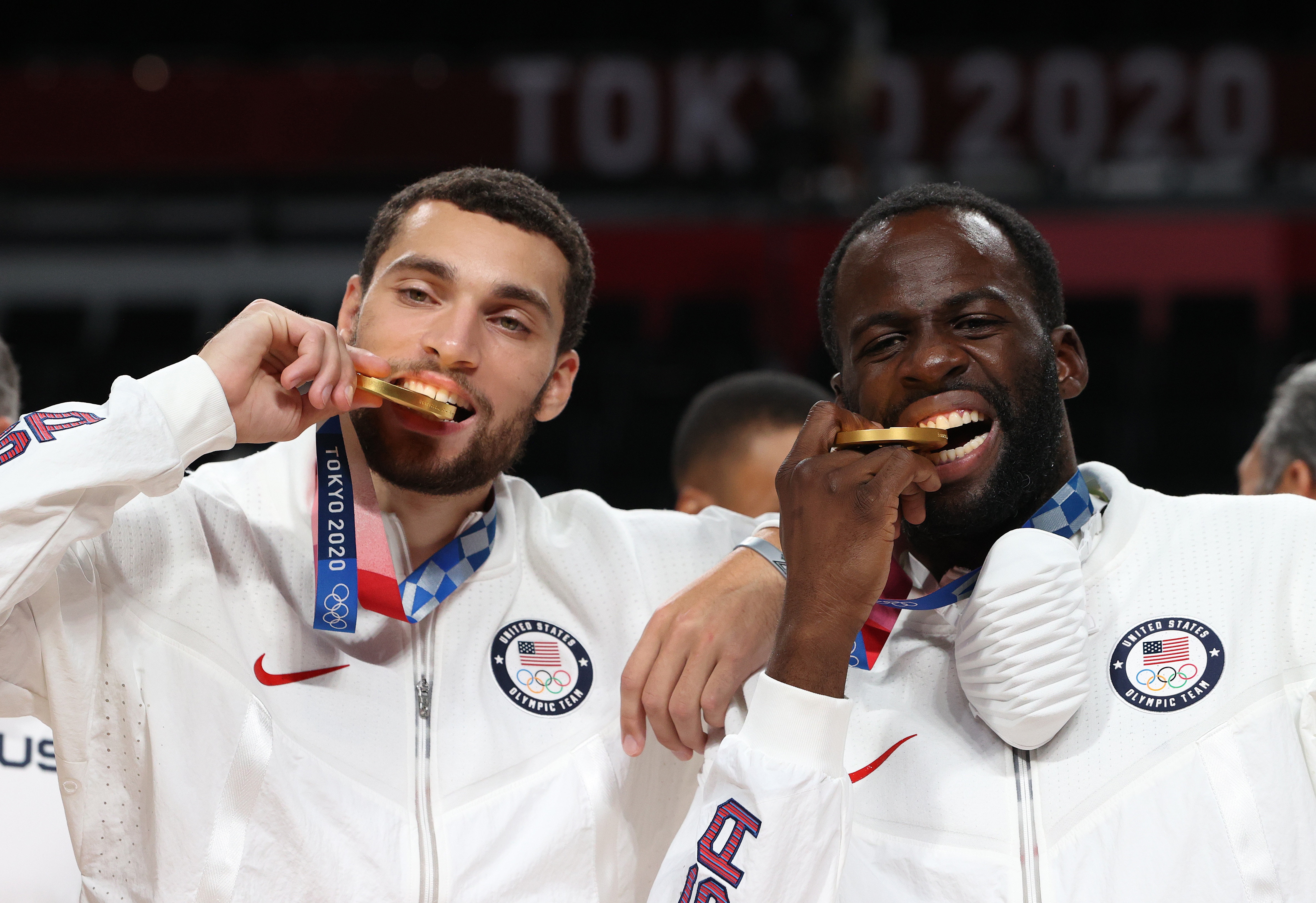SAITAMA, JAPAN - AUGUST 07: Zachary Lavine and Draymond Green of Team United States bite their gold medals during the Men's Basketball medal ceremony on day fifteen of the Tokyo 2020 Olympic Games at Saitama Super Arena on August 07, 2021 in Saitama, Japan. (Photo by Kevin C. Cox/Getty Images)