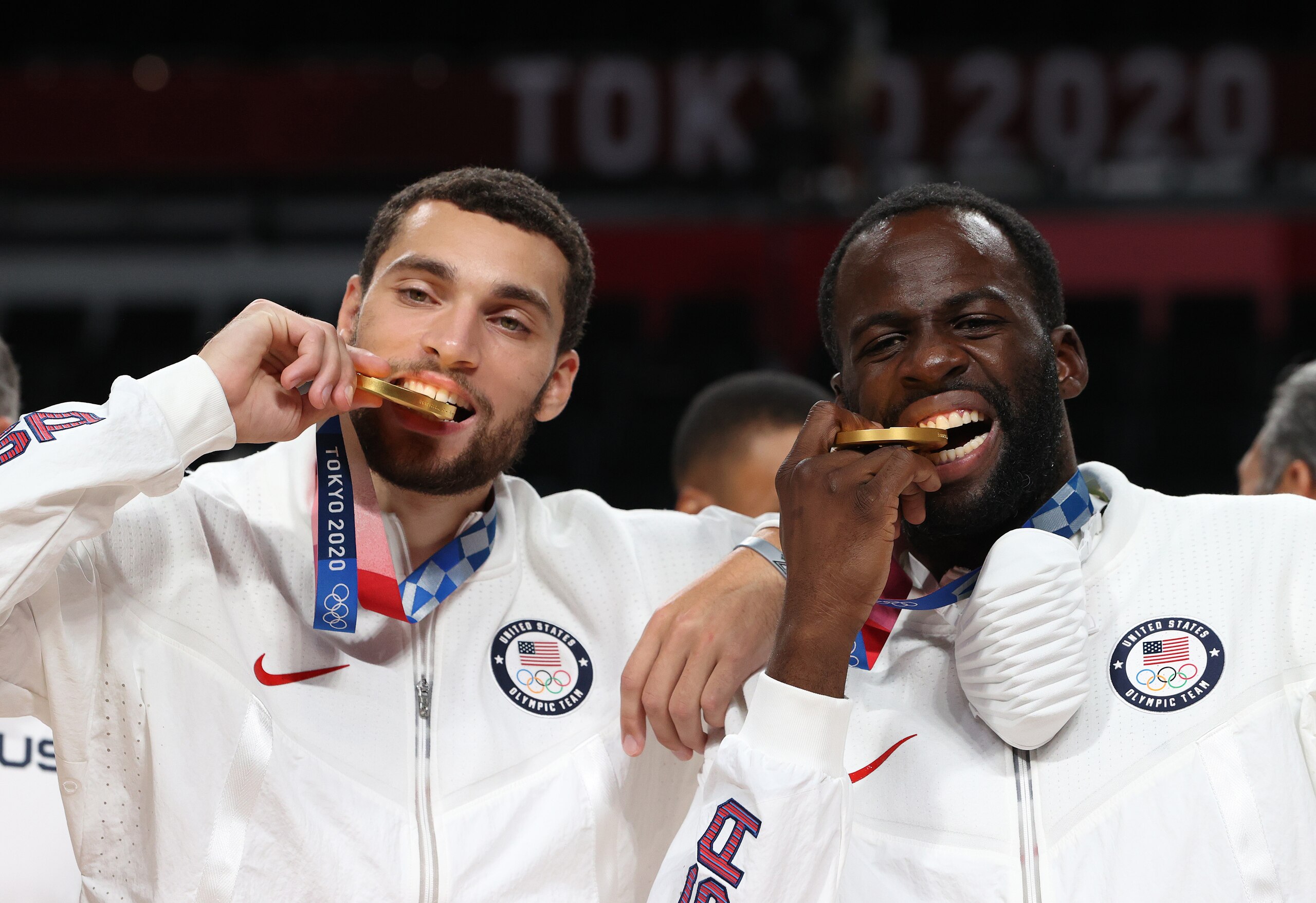 SAITAMA, JAPAN - AUGUST 07: Zachary Lavine and Draymond Green of Team United States bite their gold medals during the Men's Basketball medal ceremony on day fifteen of the Tokyo 2020 Olympic Games at Saitama Super Arena on August 07, 2021 in Saitama, Japan. (Photo by Kevin C. Cox/Getty Images)