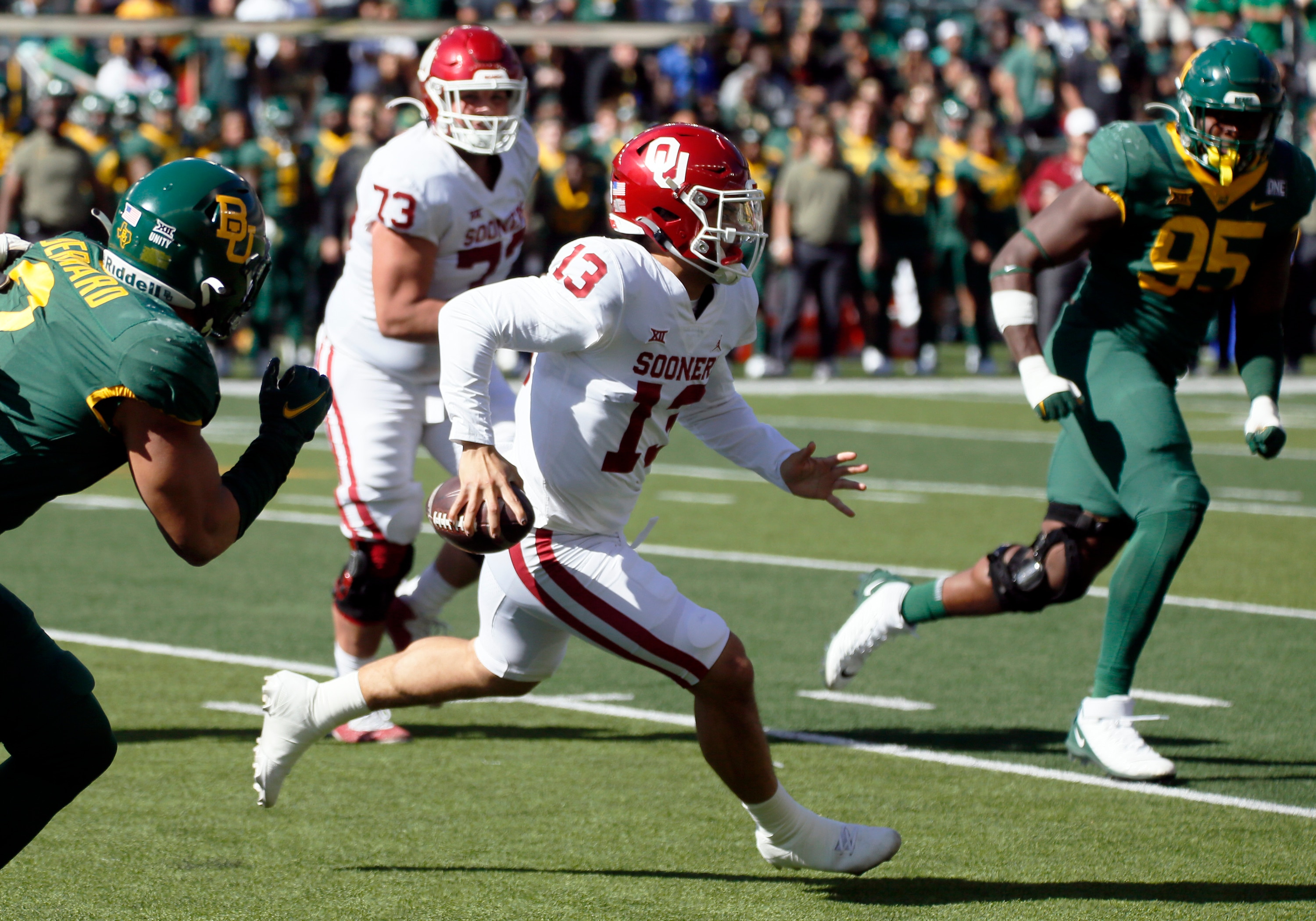 Oklahoma quarterback Caleb Williams (13) scrambles for positive yards against the Baylor during the first half of an NCAA college football game in Waco, Texas, Saturday, Nov. 13, 2021. (AP Photo/Ray Carlin)