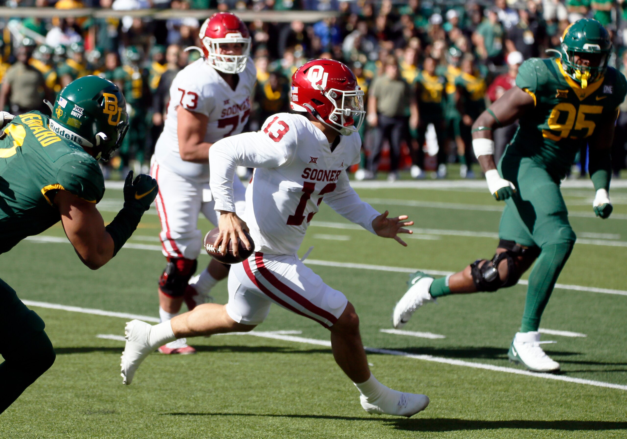Oklahoma quarterback Caleb Williams (13) scrambles for positive yards against the Baylor during the first half of an NCAA college football game in Waco, Texas, Saturday, Nov. 13, 2021. (AP Photo/Ray Carlin)
