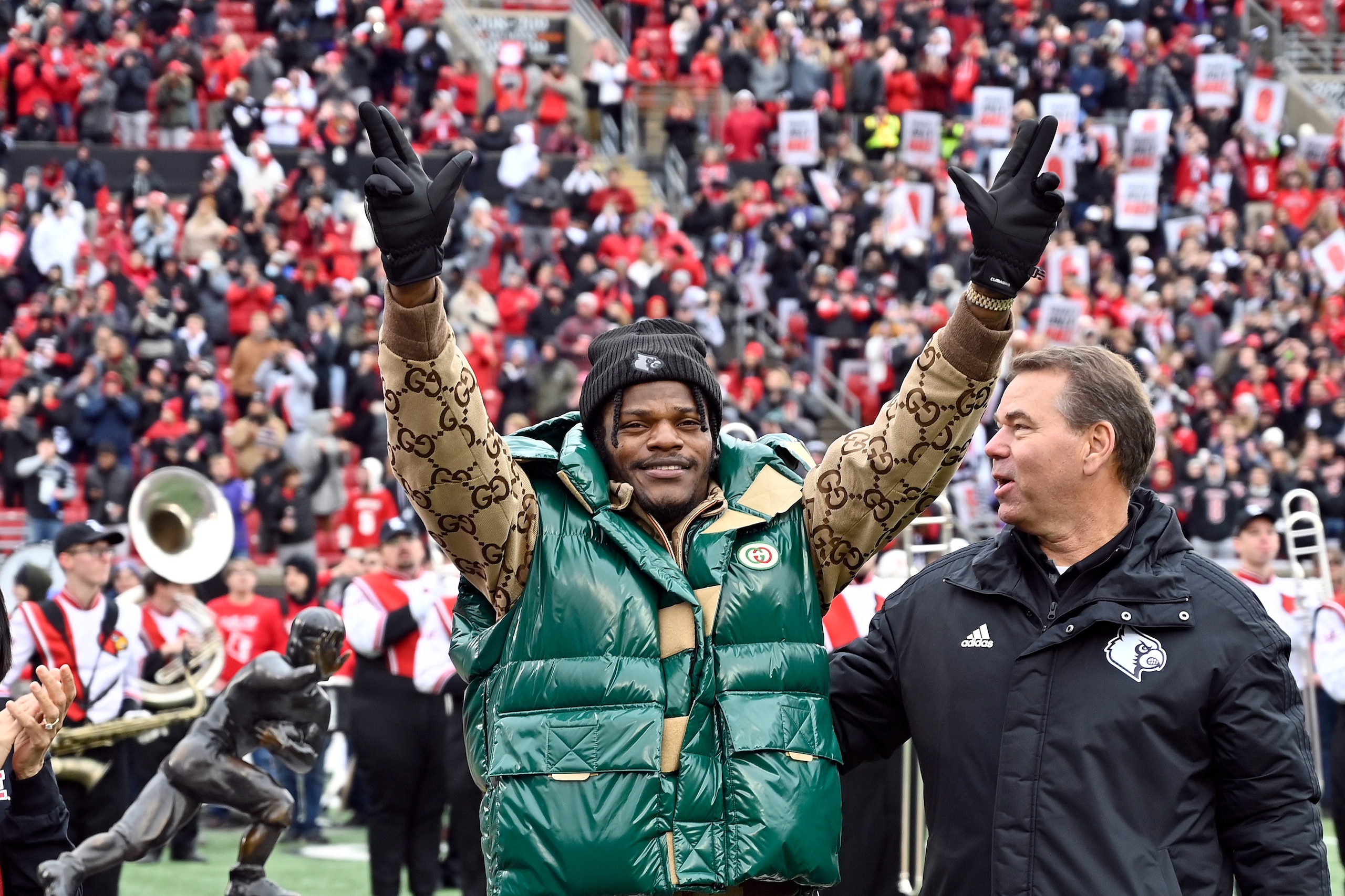 Lamar Jackson waves to the crowd during a ceremony retiring his number of his number at the University of Louisville in Louisville, Ky., Saturday, Nov. 13, 2021. (AP Photo/Timothy D. Easley)