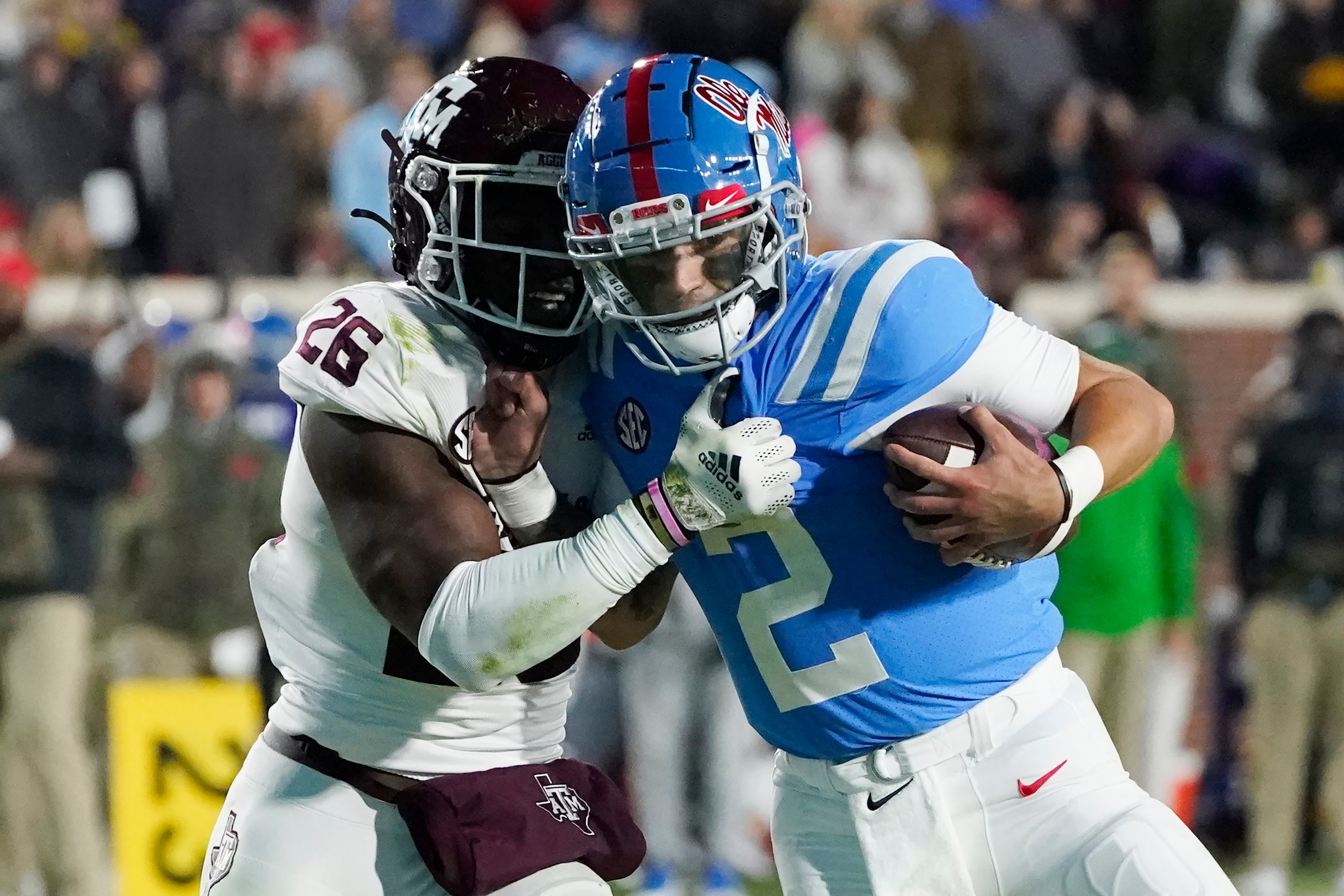 Texas A&M defensive back Demani Richardson (26) attempts to strip the ball away from Mississippi quarterback Matt Corral (2) during the first half of an NCAA college football game, Saturday, Nov. 13, 2021, in Oxford, Miss. (AP Photo/Rogelio V. Solis)
