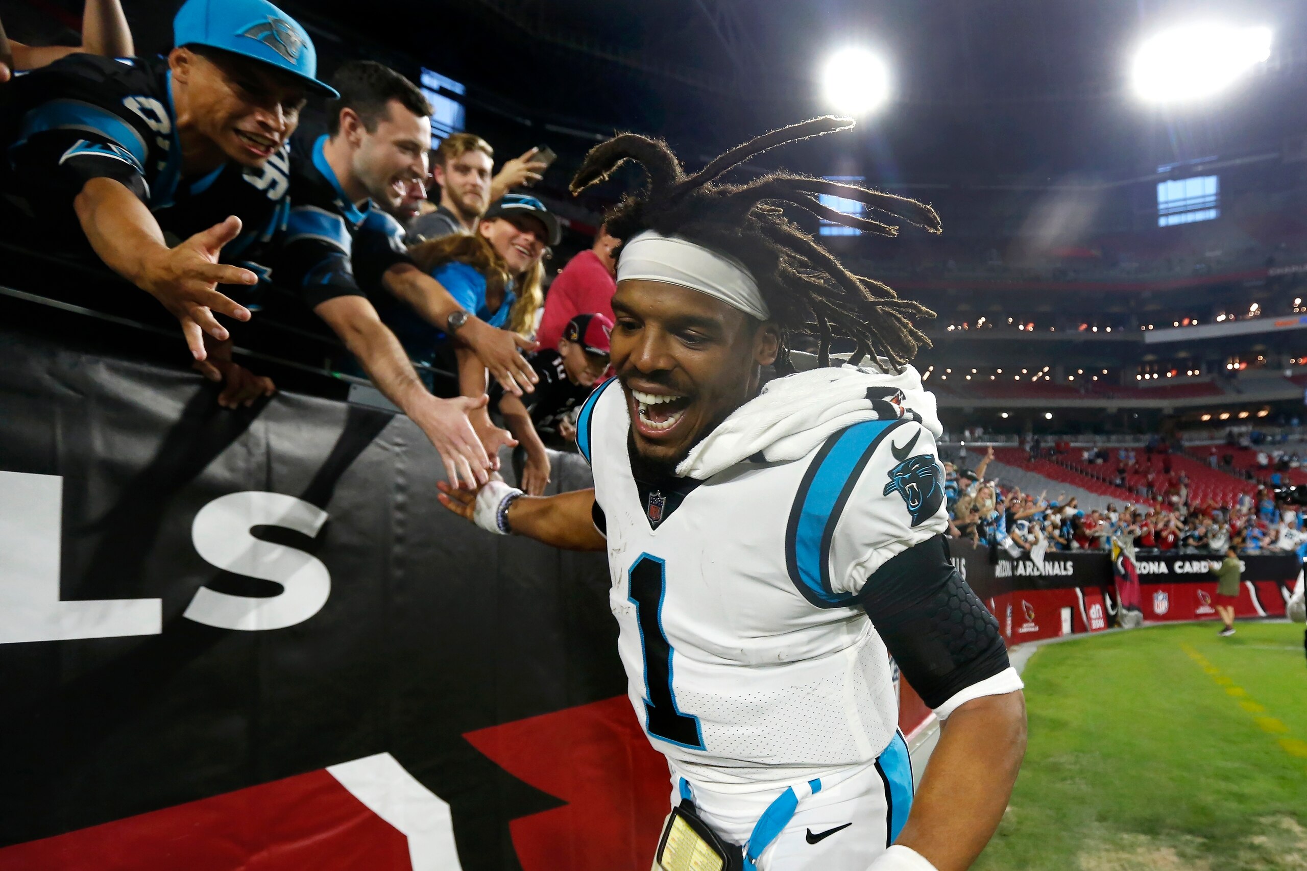 Carolina Panthers quarterback Cam Newton celebrates with Panthers fans after an NFL football game against the Arizona Cardinals Sunday, Nov. 14, 2021, in Glendale, Ariz. The Panthers defeated the Cardinals 34-10. (AP Photo/Ralph Freso)
