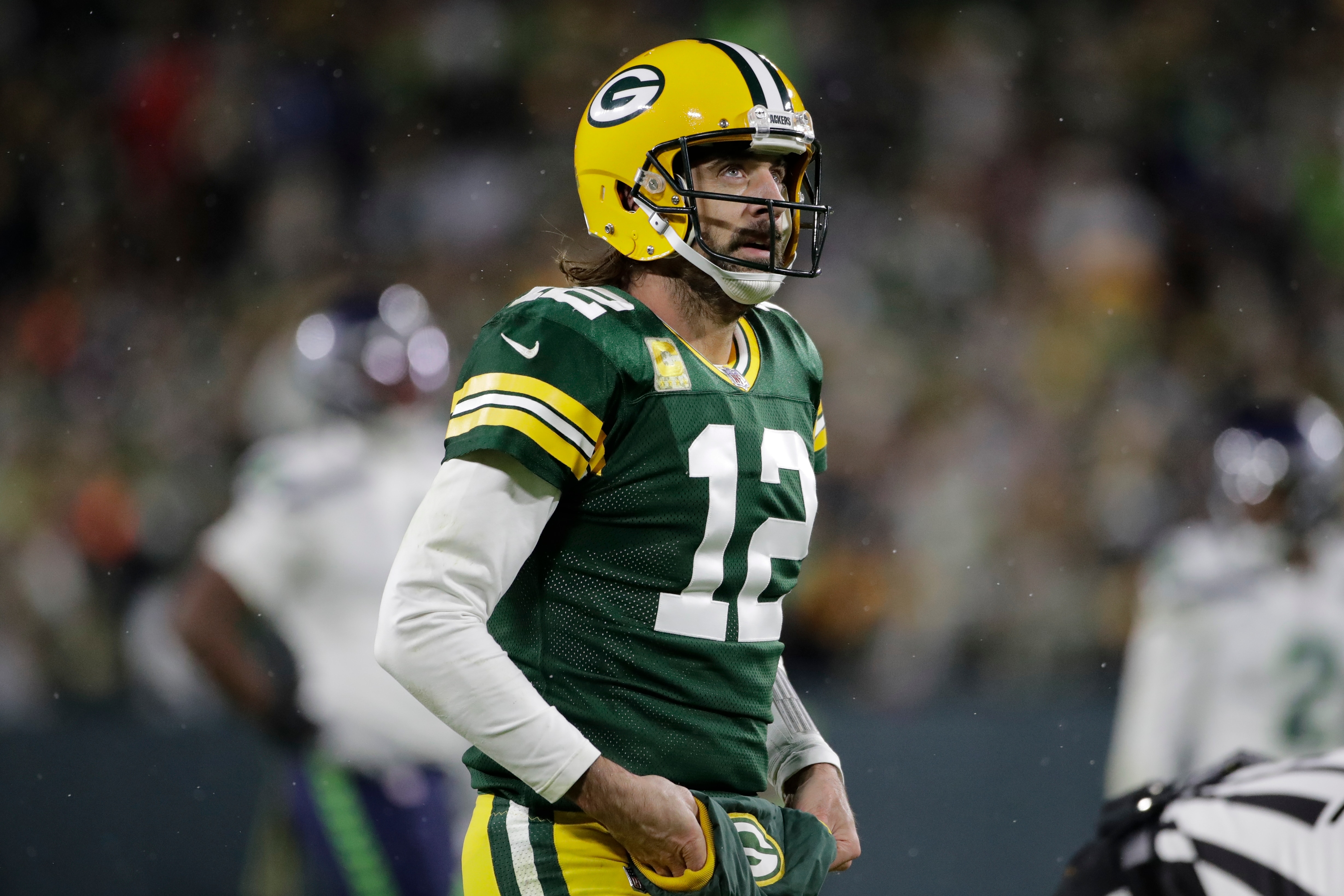 Green Bay Packers' Aaron Rodgers looks at the sc oreboard during the second half of an NFL football game against the Seattle Seahawks Sunday, Nov. 14, 2021, in Green Bay, Wis. (AP Photo/Aaron Gash)