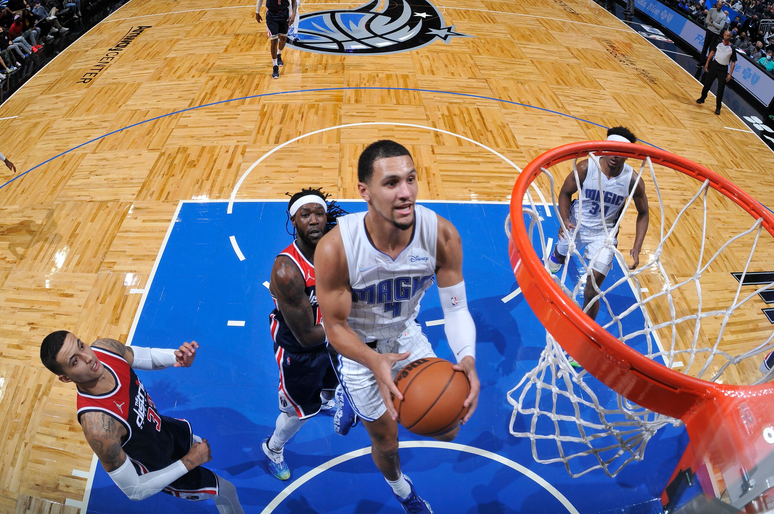 ORLANDO, FL - NOVEMBER 13: Jalen Suggs #4 of the Orlando Magic drives to the basket during the game against the Washington Wizards on November 13, 2021 at Amway Center in Orlando, Florida. NOTE TO USER: User expressly acknowledges and agrees that, by downloading and or using this photograph, User is consenting to the terms and conditions of the Getty Images License Agreement. Mandatory Copyright Notice: Copyright 2021 NBAE (Photo by Fernando Medina/NBAE via Getty Images)