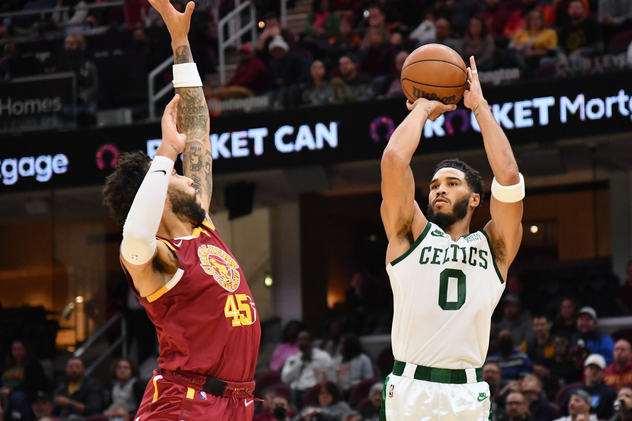 CLEVELAND, OHIO - NOVEMBER 15: Jayson Tatum #0 of the Boston Celtics shoots over Denzel Valentine #45 of the Cleveland Cavaliers during the fourth quarter at Rocket Mortgage Fieldhouse on November 15, 2021 in Cleveland, Ohio. The Celtics defeated the Cavaliers 98-92. NOTE TO USER: User expressly acknowledges and agrees that, by downloading and/or using this photograph, user is consenting to the terms and conditions of the Getty Images License Agreement. (Photo by Jason Miller/Getty Images)