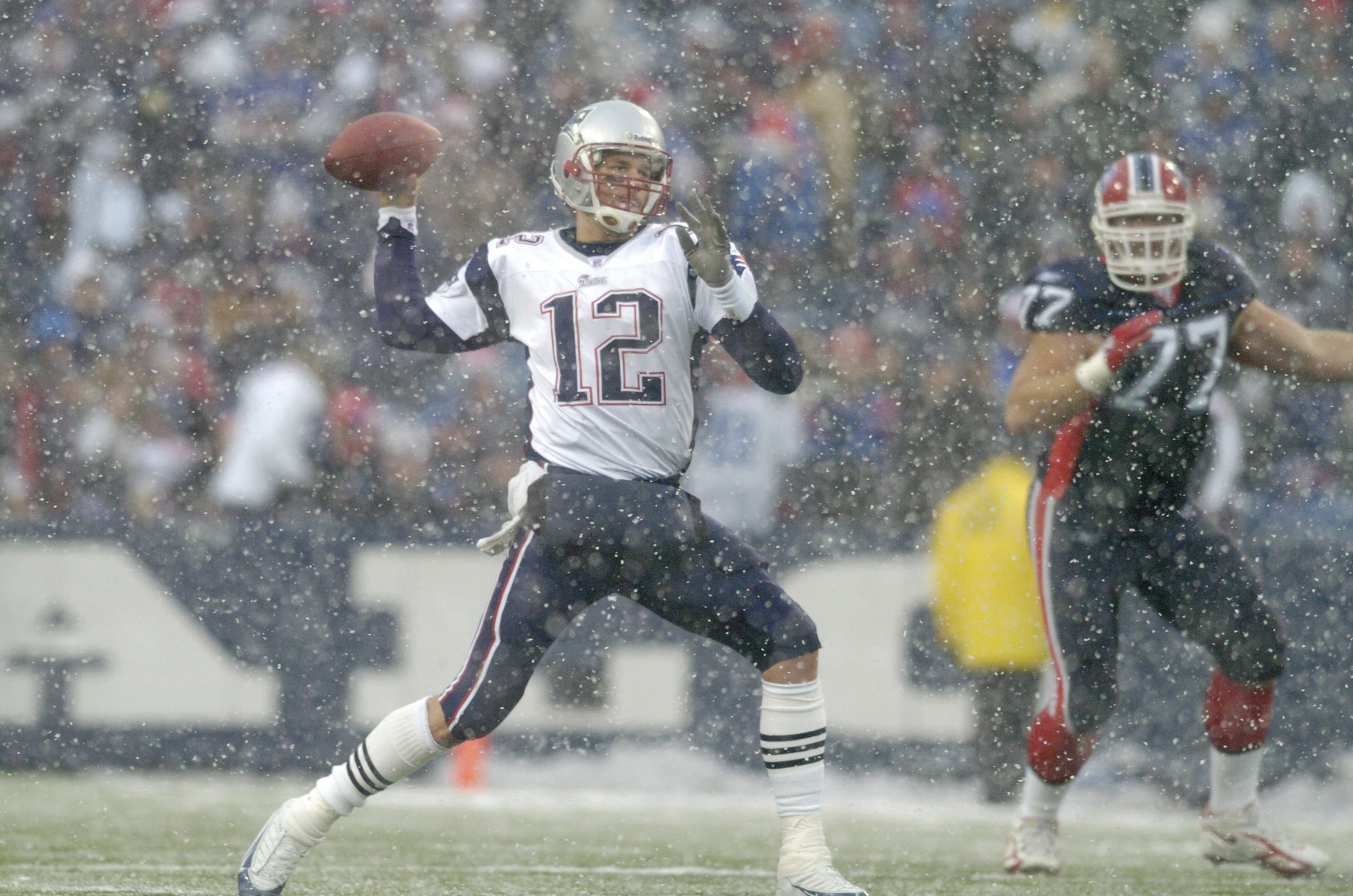 New England Patriots quarterback Tom Brady throws in the snow during a game against the Buffalo Bills at Ralph Wilson Stadium in Orchard Park, New York on December 11, 2005. New England won the game 35-7. (Photo by Mark Konezny/Getty Images)
