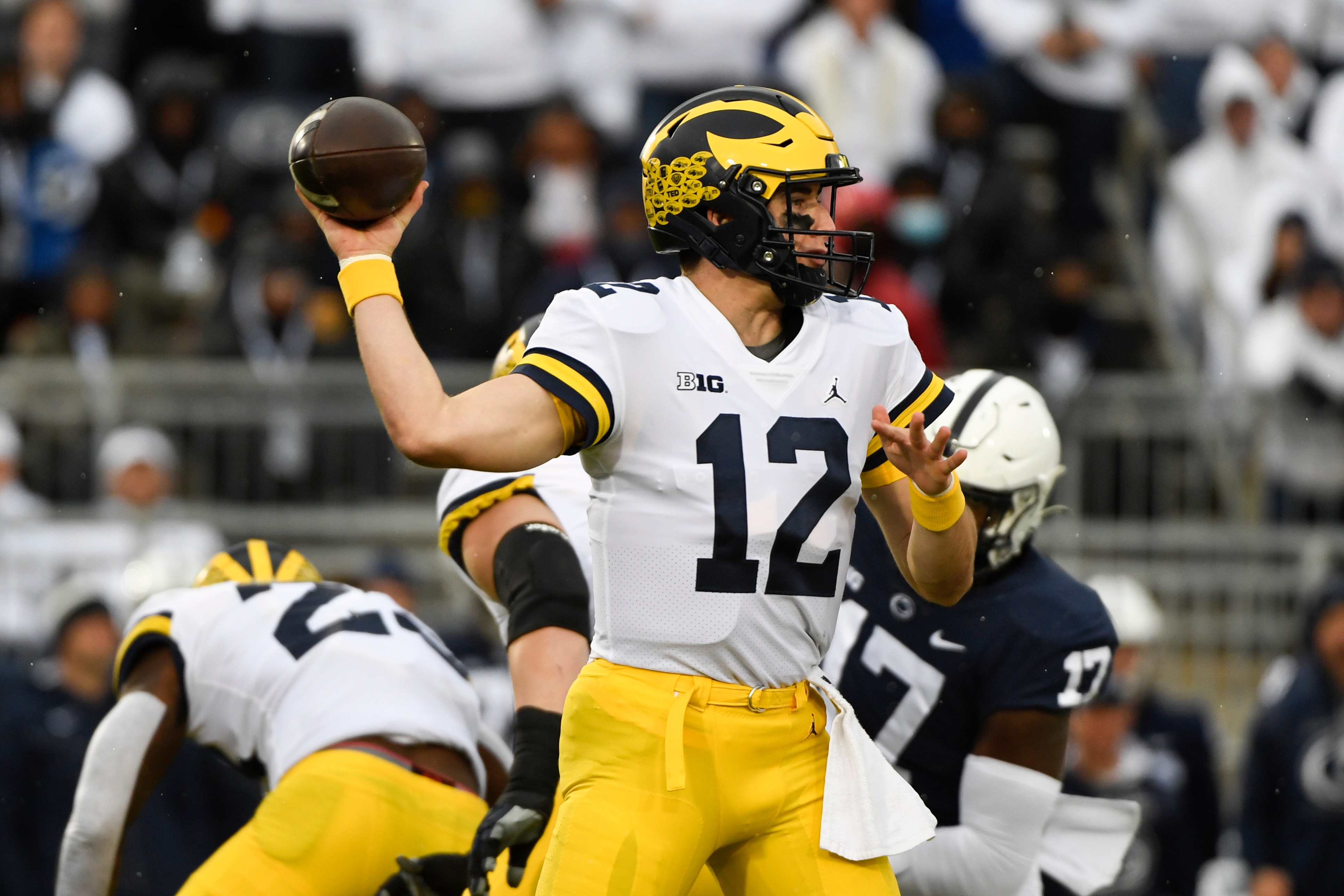 Michigan quarterback Cade McNamara (12) passes against Penn State during an NCAA college football game in State College, Pa., Saturday, Nov. 13, 2021. (AP Photo/Barry Reeger)