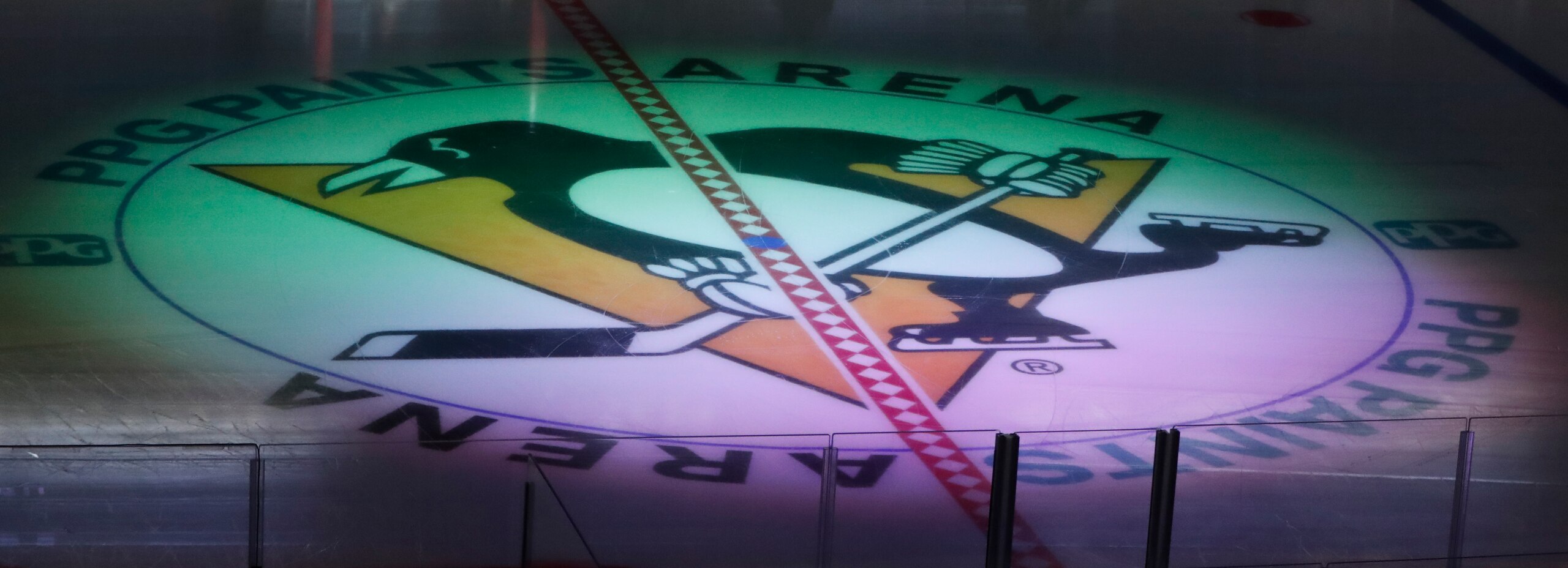 The Pittsburgh Penguins logo at center ice is lit by a spotlight before the start of the first period of an NHL preseason hockey game against the Columbus Blue Jackets, Saturday, Sept. 22, 2018, in Pittsburgh. (AP Photo/Keith Srakocic)