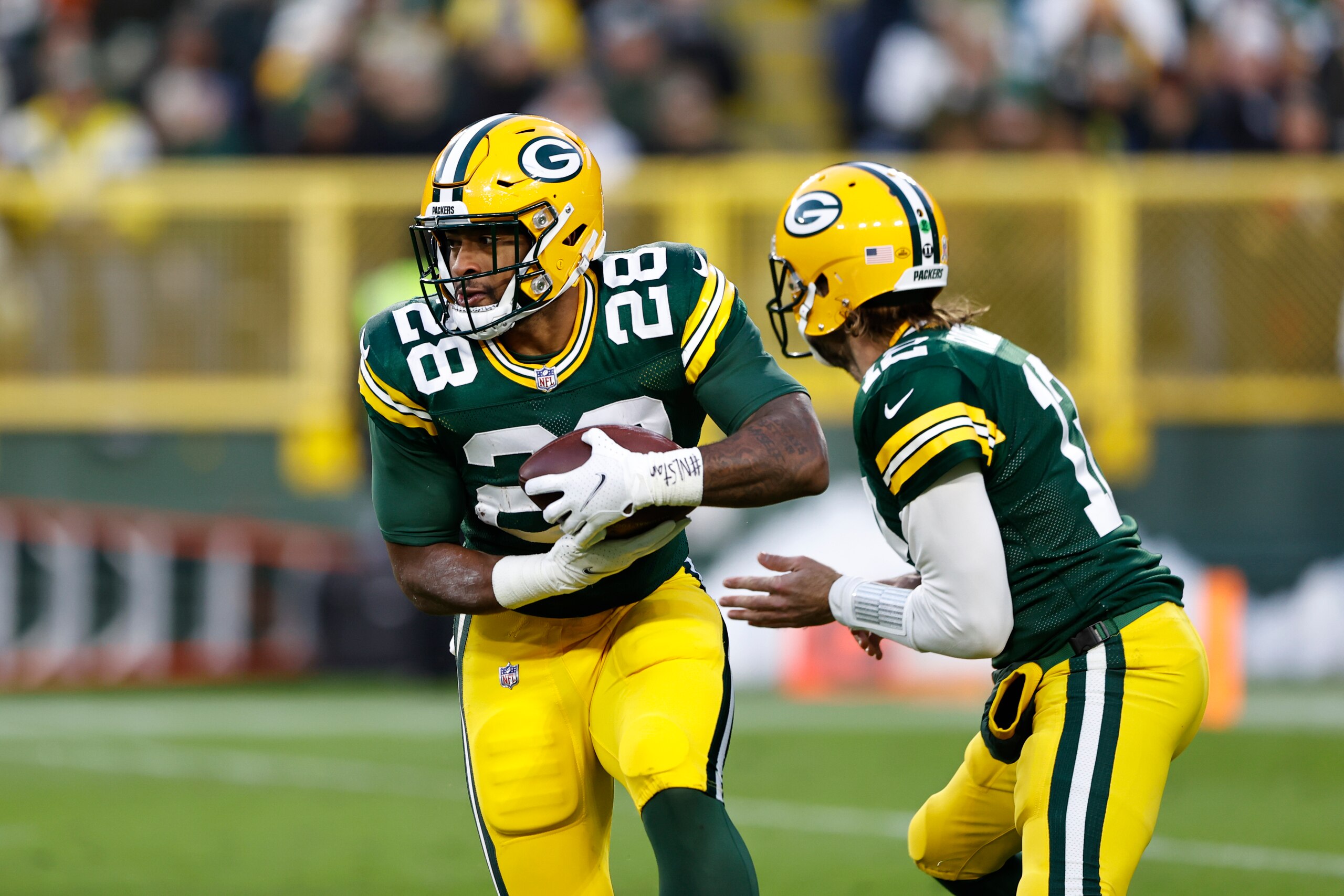 Green Bay Packers running back A.J. Dillon (28) runs with the ball during the first half of an NFL football game against the Seattle Seahawks, Sunday, Nov. 14, 2021, in Green Bay, Wis. (AP Photo/Kamil Krzaczynski)