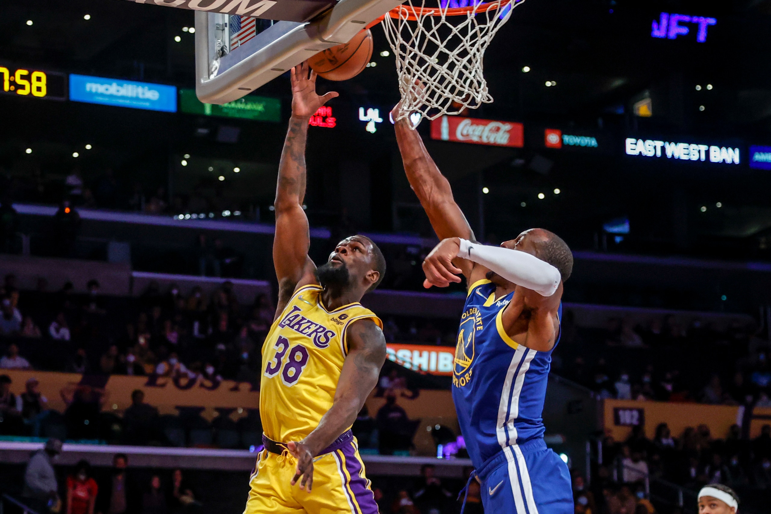 Los Angeles Lakers guard Chaundee Brown Jr. (38) goes up to basket while defended by Golden State Warriors forward Andre Iguodala (9) during the first half of a preseason NBA basketball game in Los Angeles, Tuesday, Oct. 12, 2021. (AP Photo/Ringo H.W. Chiu)